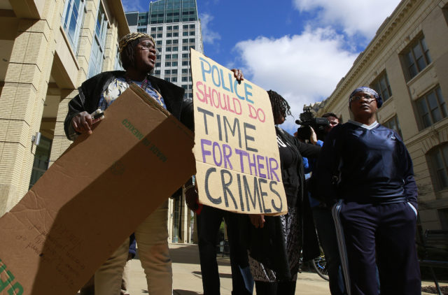 Demonstrators gather outside Sacramento City Hall (Rich Pedroncelli/AP)