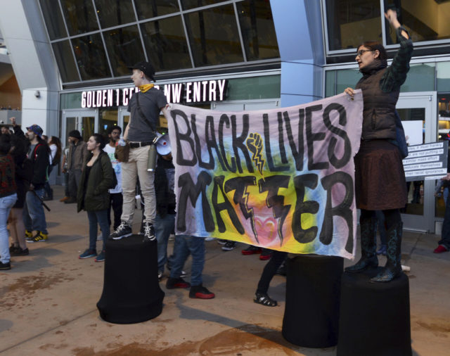 Black Lives Matter and other demonstrators protesting this week's fatal shooting of an unarmed black man gather outside Golden 1 Centre before an NBA basketball game (Robert Petersen/AP)