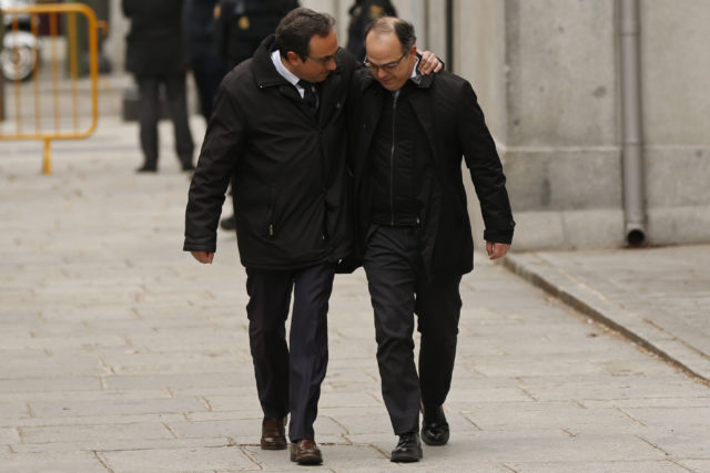 Catalan presidential candidate Jordi Turull, right, and former cabinet member Josep Rull arrive at the Supreme Court in Madrid (Francisco Seco/AP)