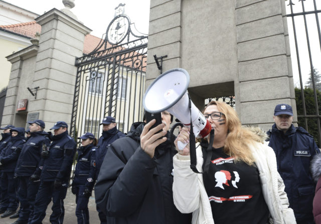 Protesters in front of the bishops' residence in Warsaw (Alik Keplicz/AP)