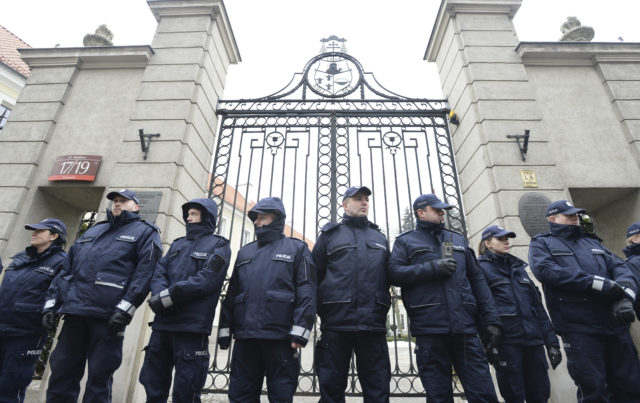 Police officers guard the entrance to the bishops' residence (Alik Keplicz/AP)
