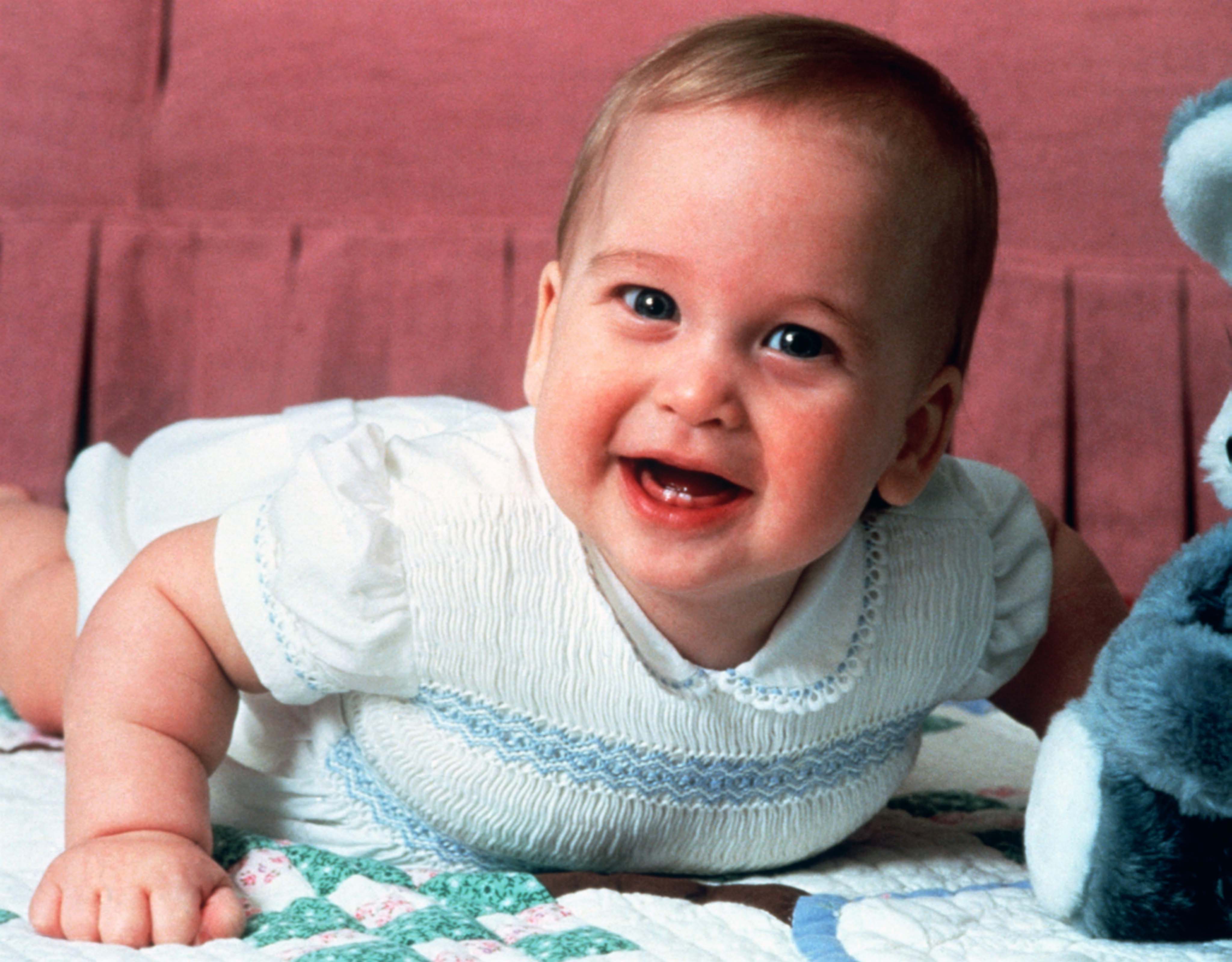 Baby Prince William playing at home in Kensington Palace, London (PA)