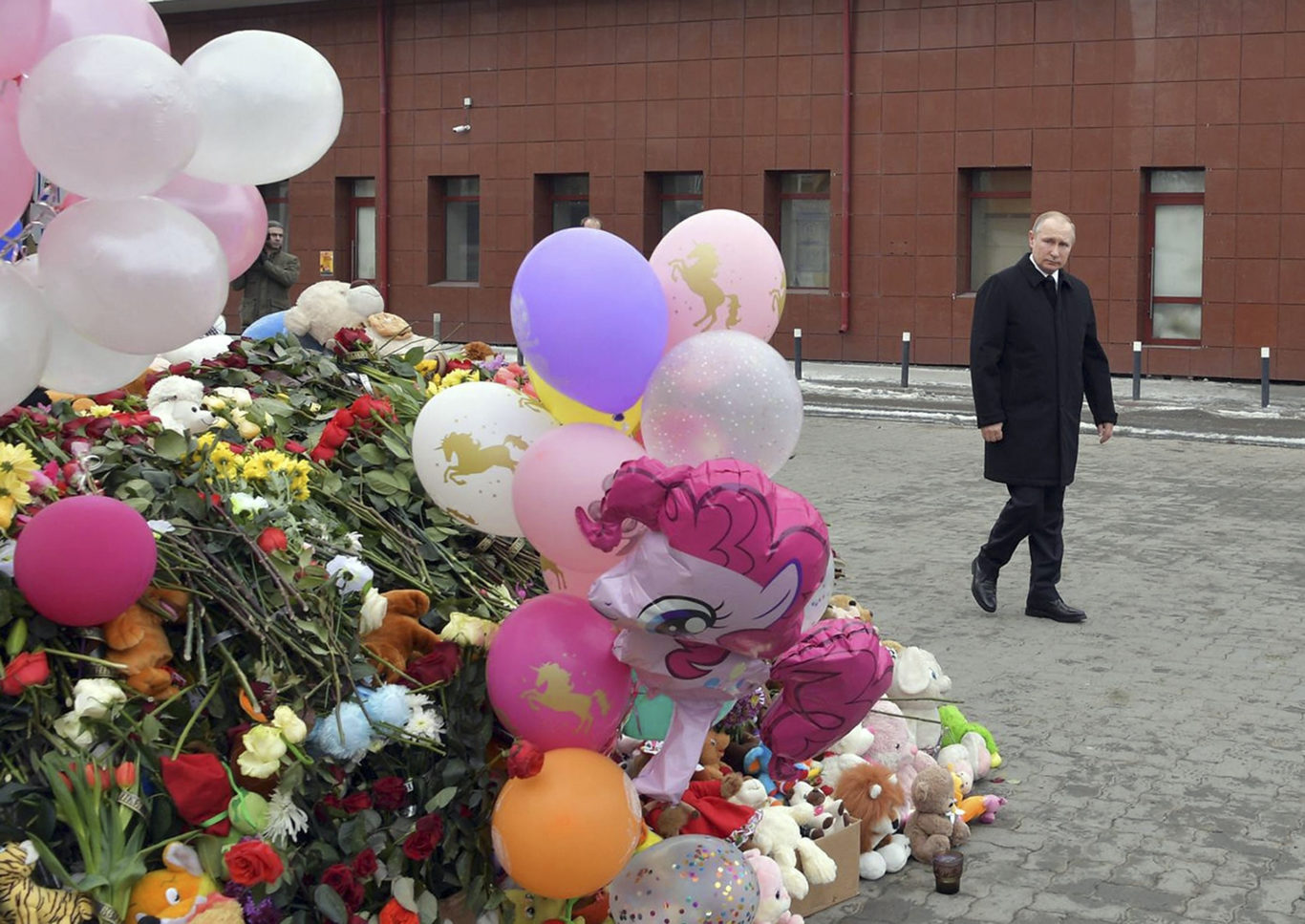 Vladimir Putin visits a memorial for the victims of the fire (Alexei Druzhinin/Sputnik/ Kremlin Pool Photo via AP/PA)