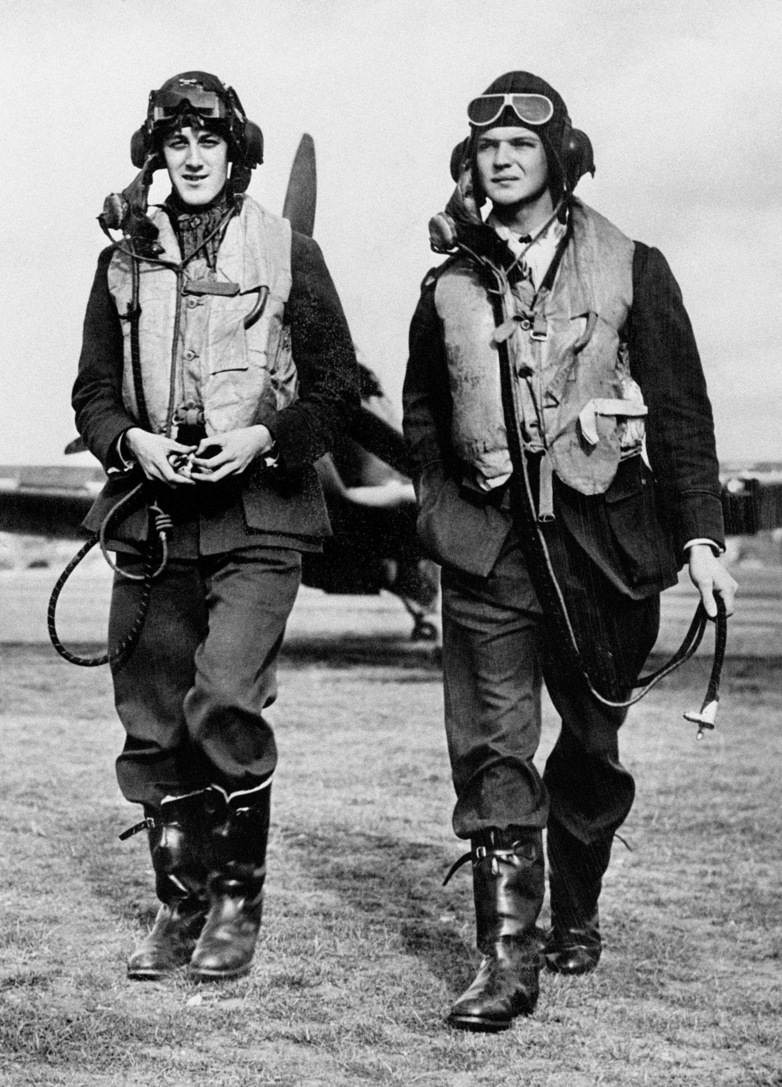 Two Royal Air Force pilots from Fighter Command walking from an aircraft during the Second World War (PA)
