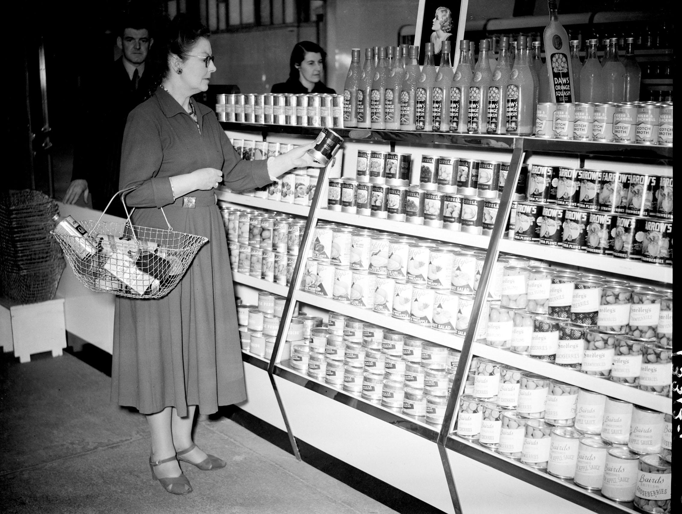 A customer pictured in a 'help yourself shop' in 1949 (PA Archive)