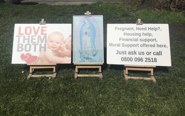 Posters displayed on the grass verge opposite the Marie Stopes clinic (Jemma Crew/PA)