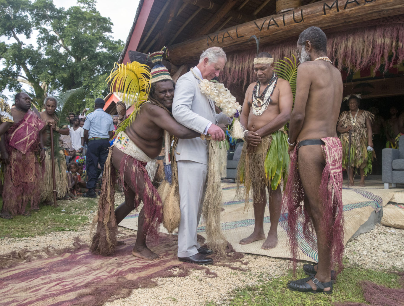 Charles is given a grass skirt to wear prior to receiving a chiefly title during a visit to the Chiefs' Nakamal, as he visits the South Pacific island of Vanuatu during his tour of the region (Steve Parsons/PA)