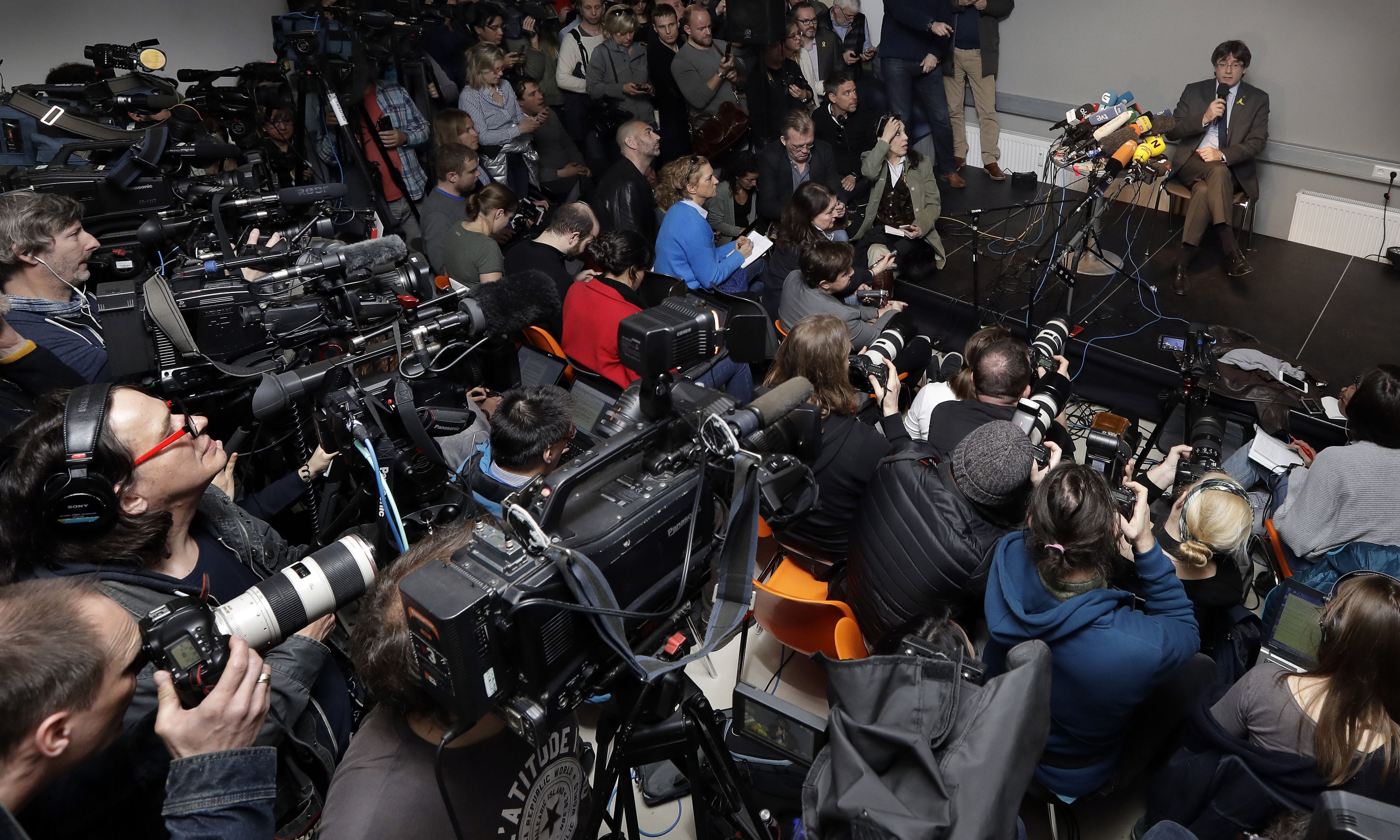 Carles Puigdemont, top right, attends a news conference in Berlin (Michael Sohn/AP)