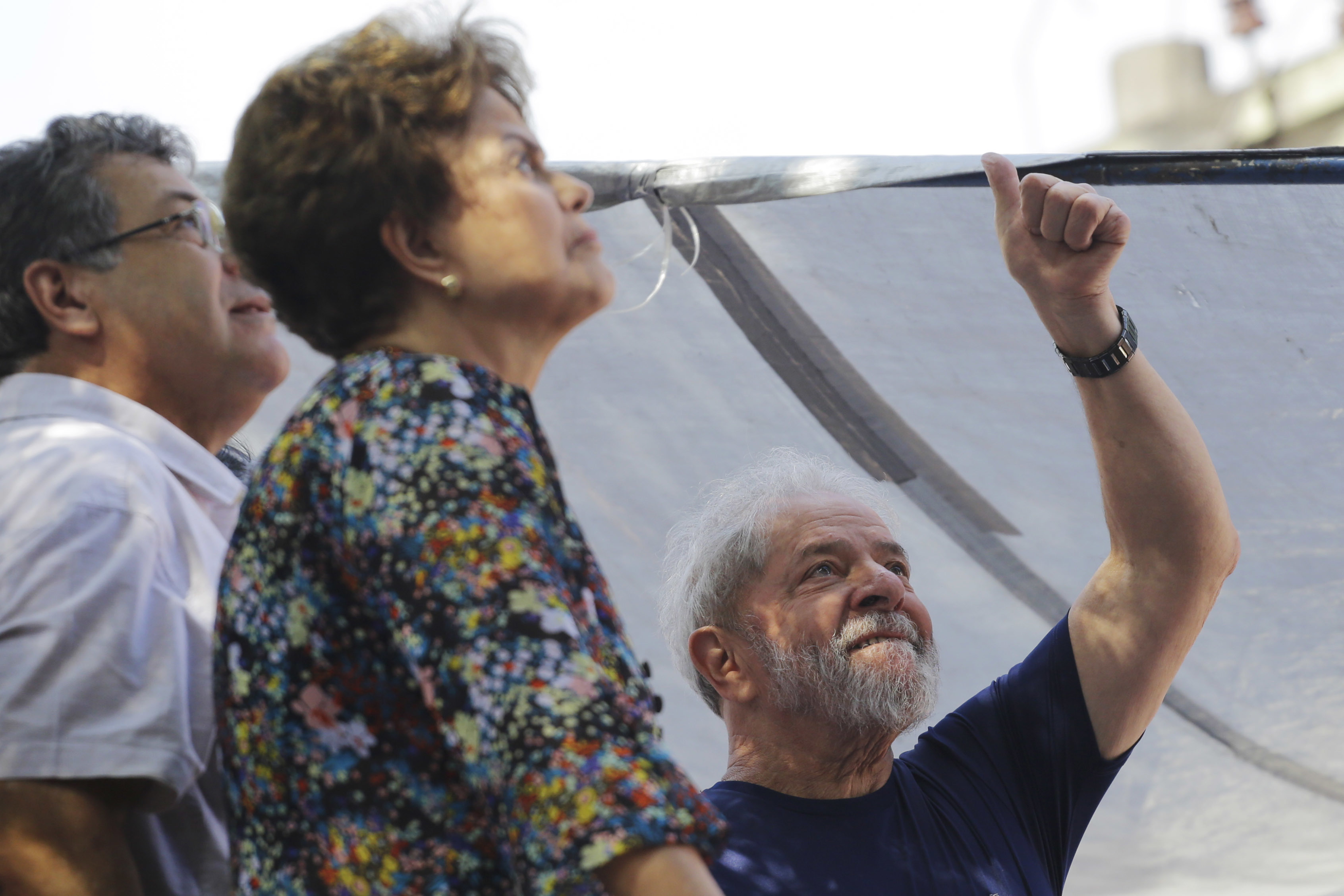Brazil's former presidents Luiz Inacio Lula da Silva, right, and Dilma Rousseff, second left, in front of the metal workers union headquarters (Nelson Antoine/AP)