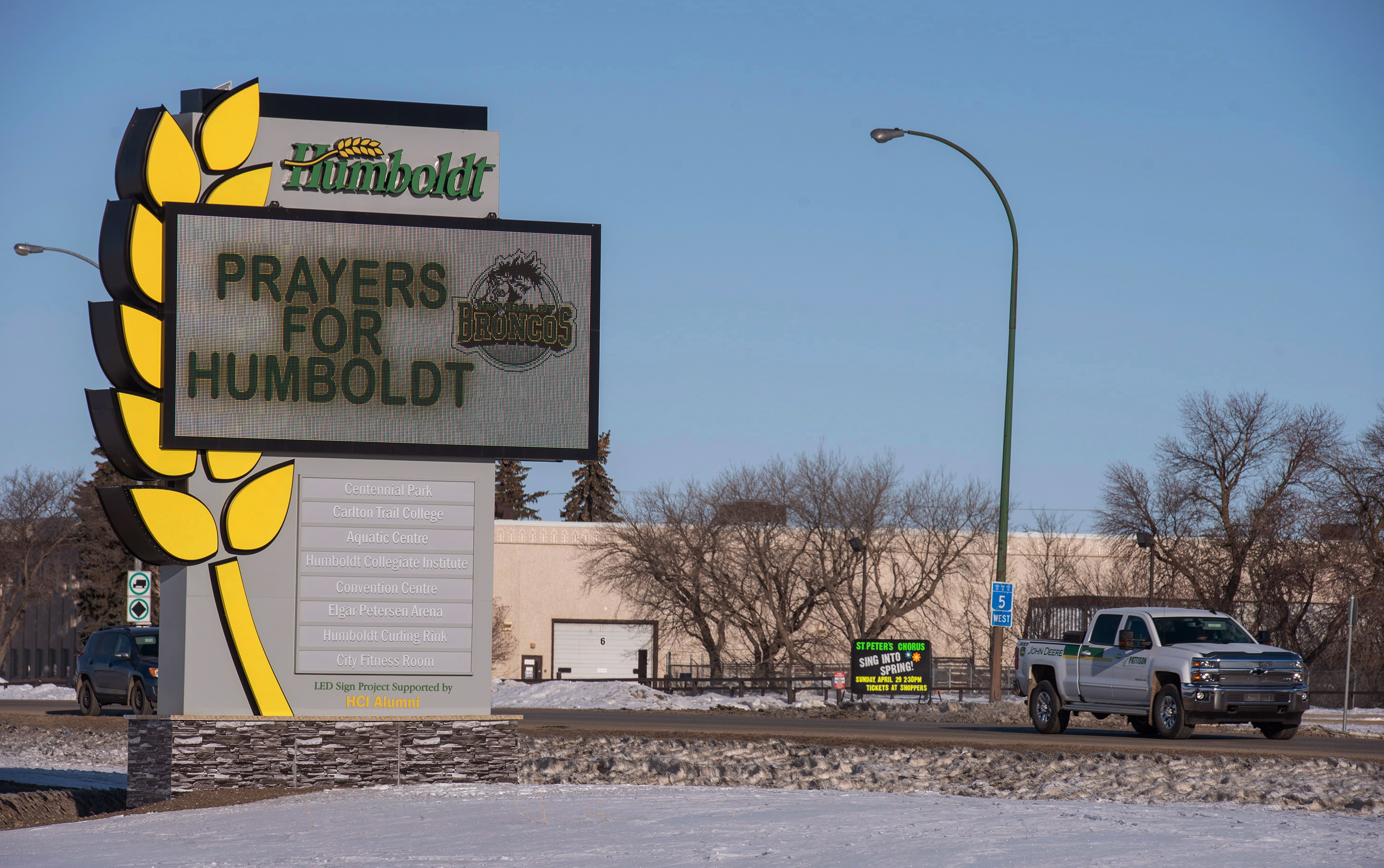 A truck drives by the welcome sign honouring the members of the Humboldt Broncos hockey team (Liam Richards/The Canadian Press via AP)