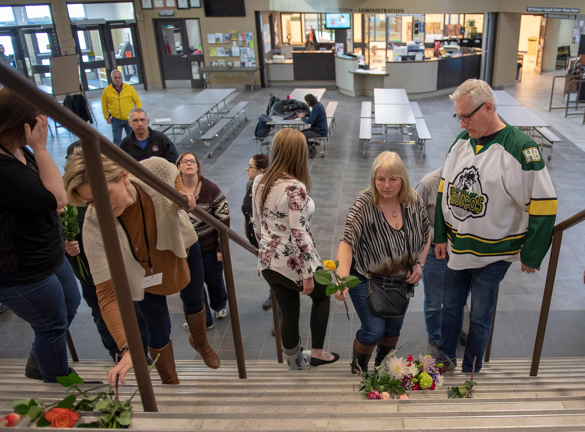 Humboldt mayor Rob Muench, in a Broncos top, with other mourners at Elgar Petersen Arena, home of the Humboldt Broncos (Liam Richards/The Canadian Press via AP)