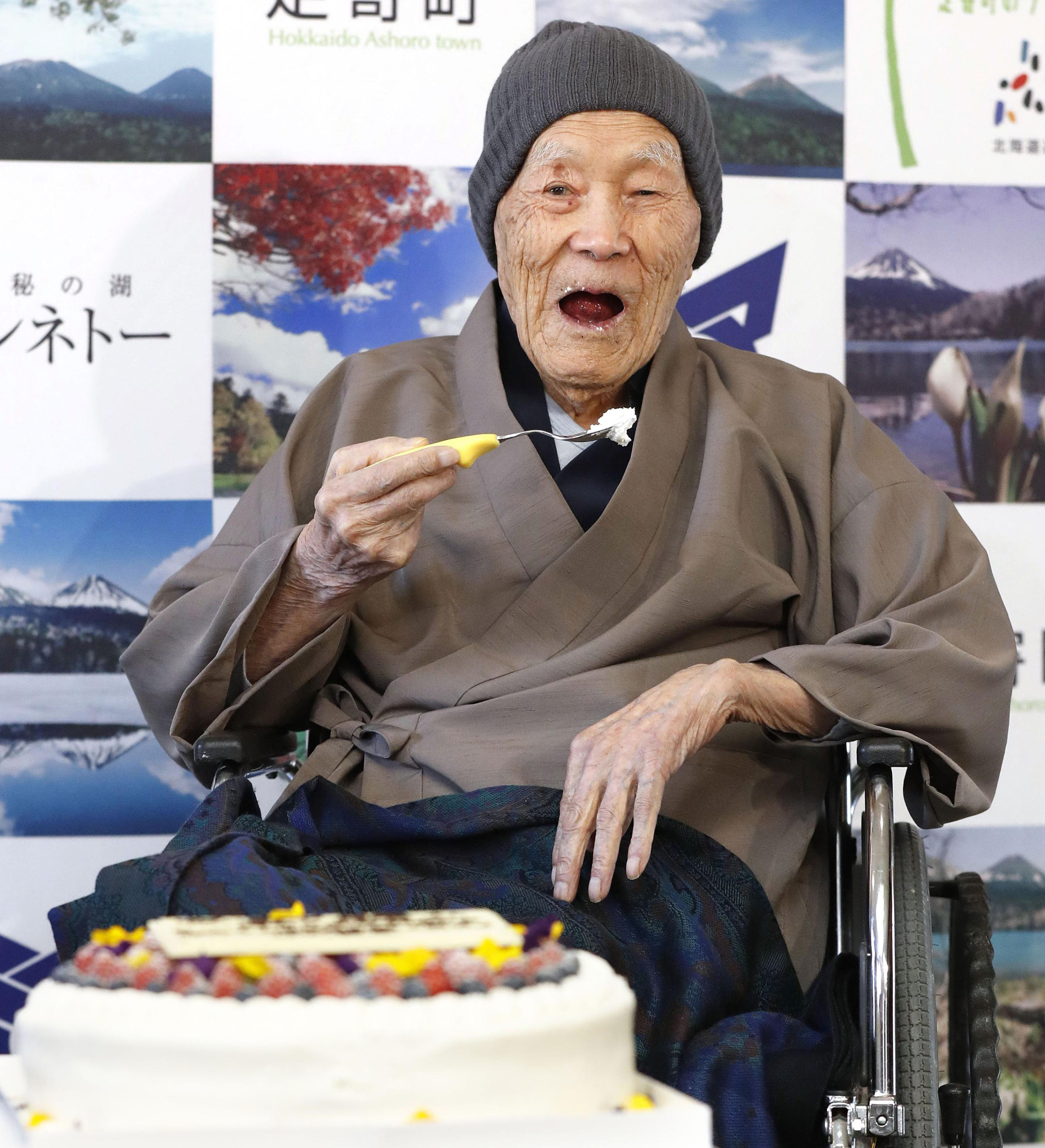 Masazou Nonaka eats cake after receiving the certificate from Guinness World Records as the world's oldest living man (Masanori Takei/Kyodo News via AP)