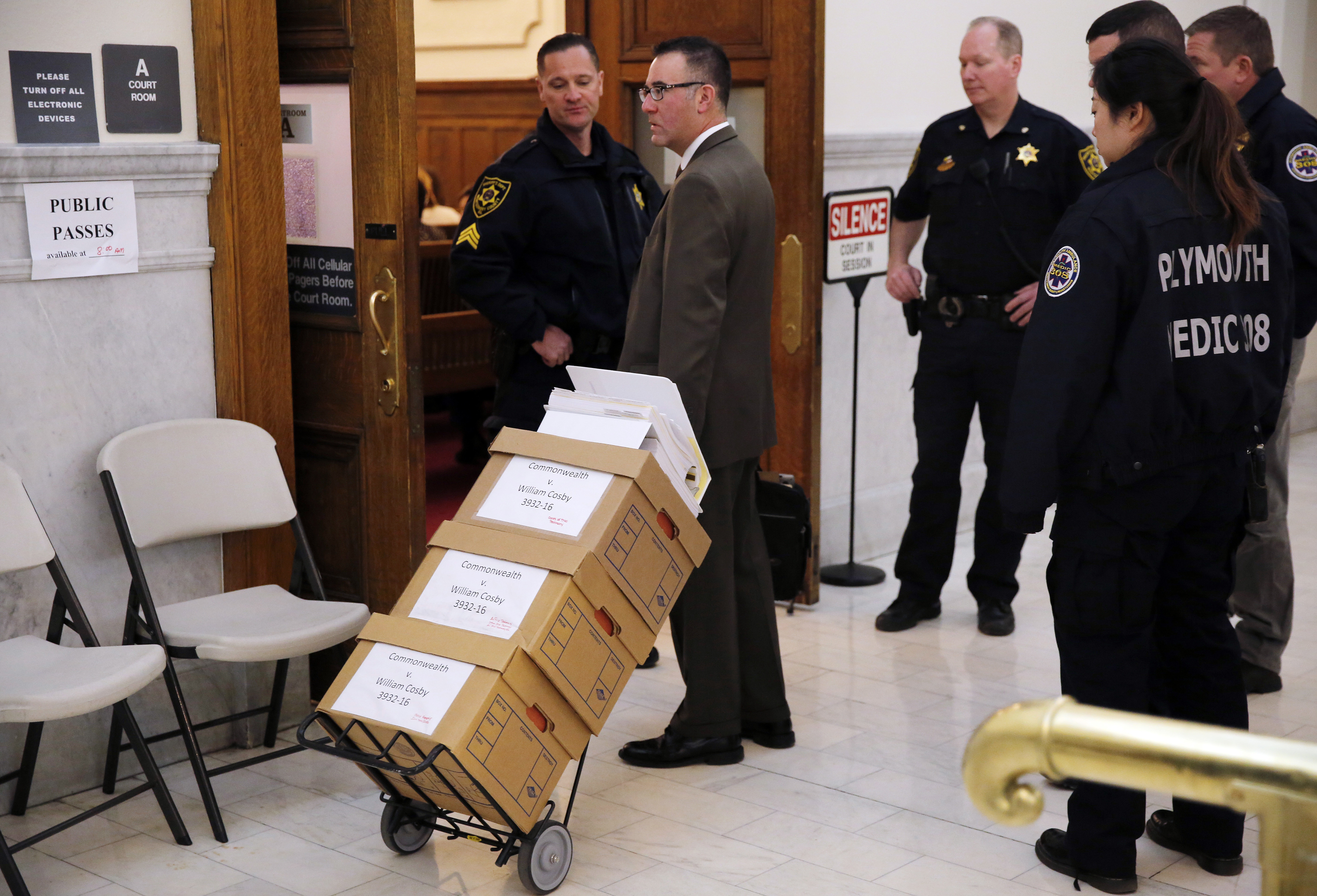 Boxes of documents are wheeled into the courtroom during the retrial of comedian Bill Cosby (Dominick Reuter/Pool Photo via AP)