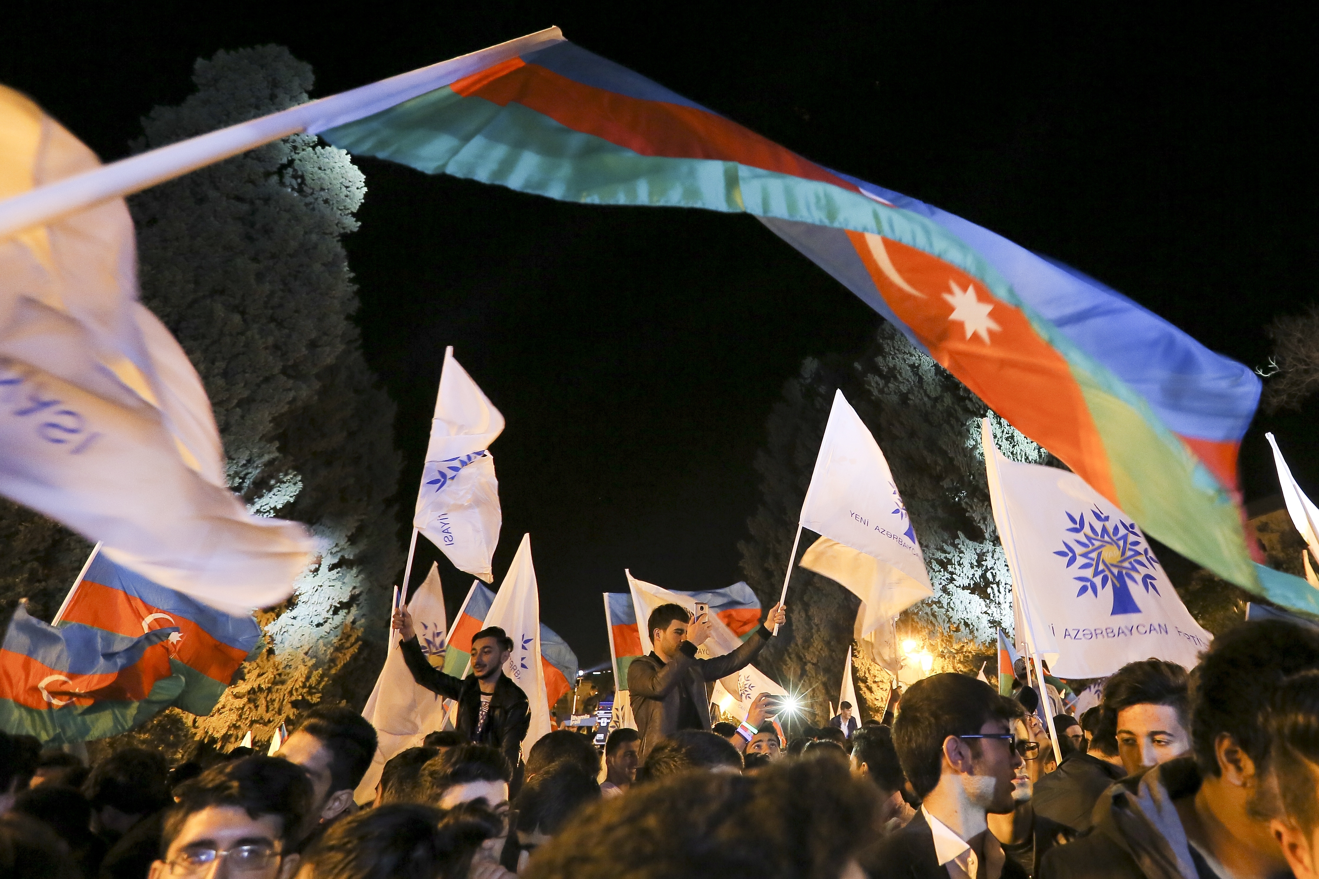 Supporters of Ilham Aliyev celebrate his victory in the presidential elections in Baku (Aziz Karimov/AP/PA)