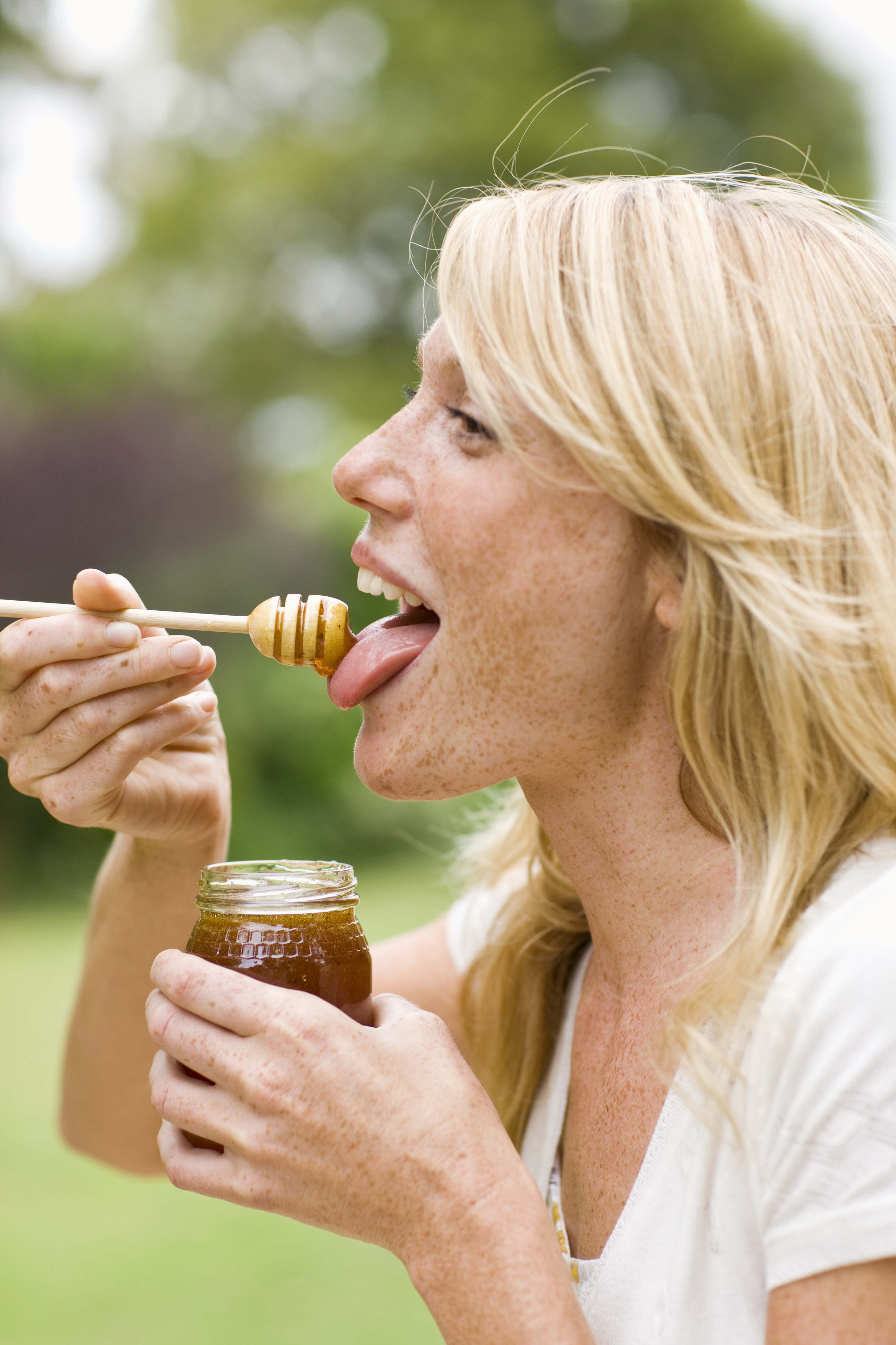 A woman tasting honey