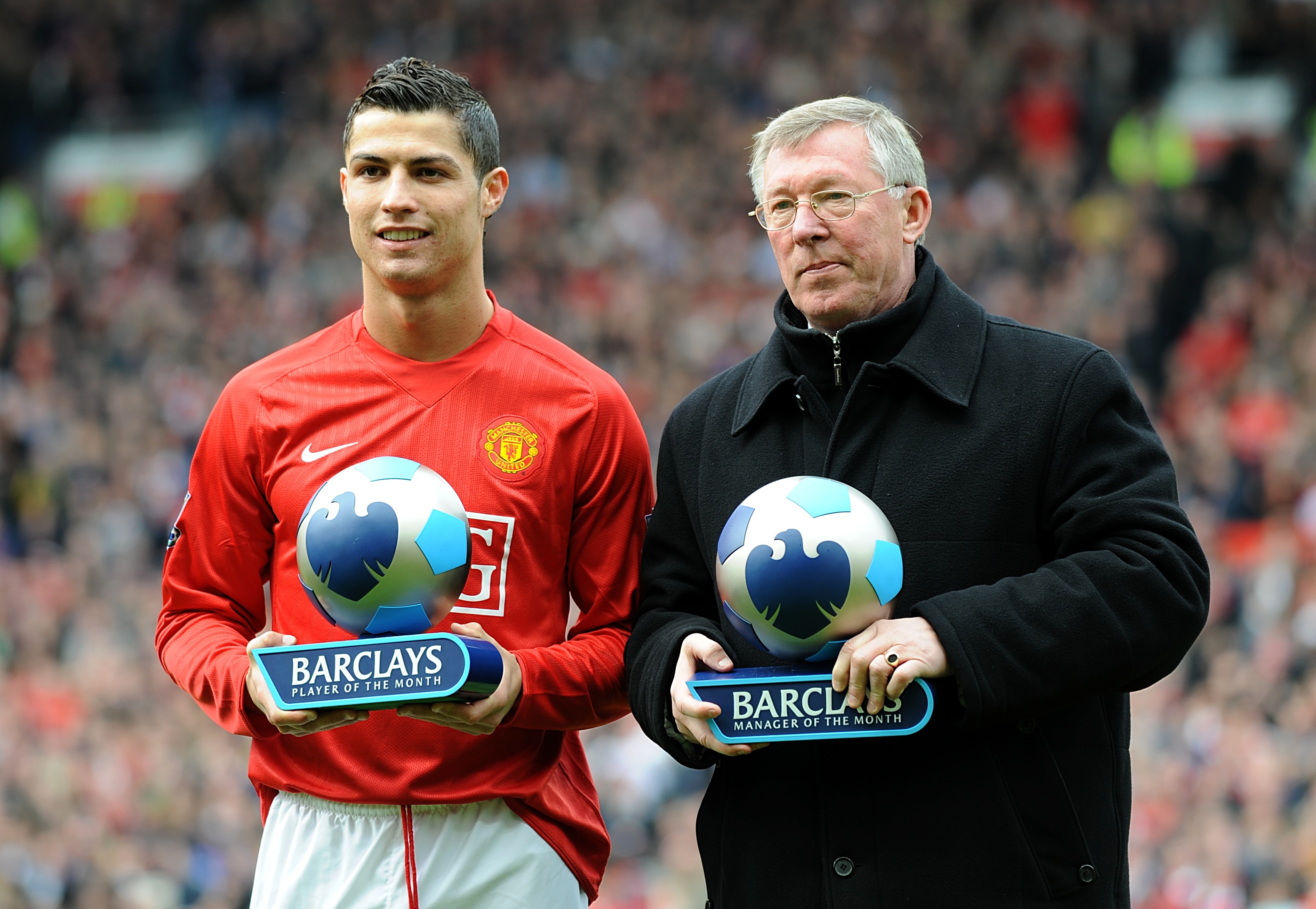 Cristiano Ronaldo and Sir Alex Ferguson receive trophies during their time at Manchester United