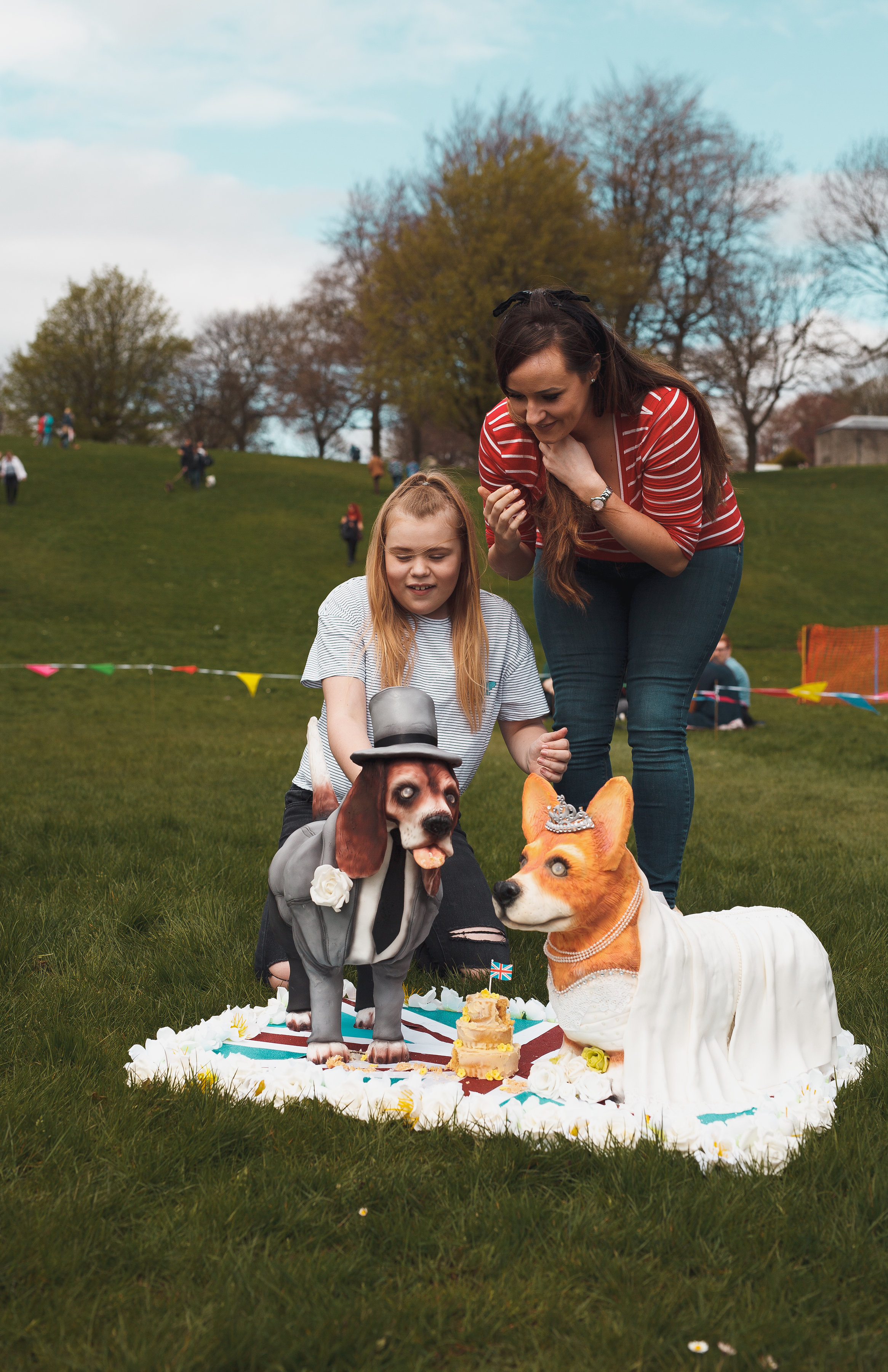 Olivia Benn cuts the cake which looks like a corgi, baked to mark her invitation to Meghan and Harry's wedding (AlexanderWard.com)