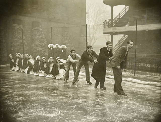Photos show off-duty fun, such as this one of nurses and students ice-skating on a tennis court at the London Fever Hospital (Historic England Archive/PA)