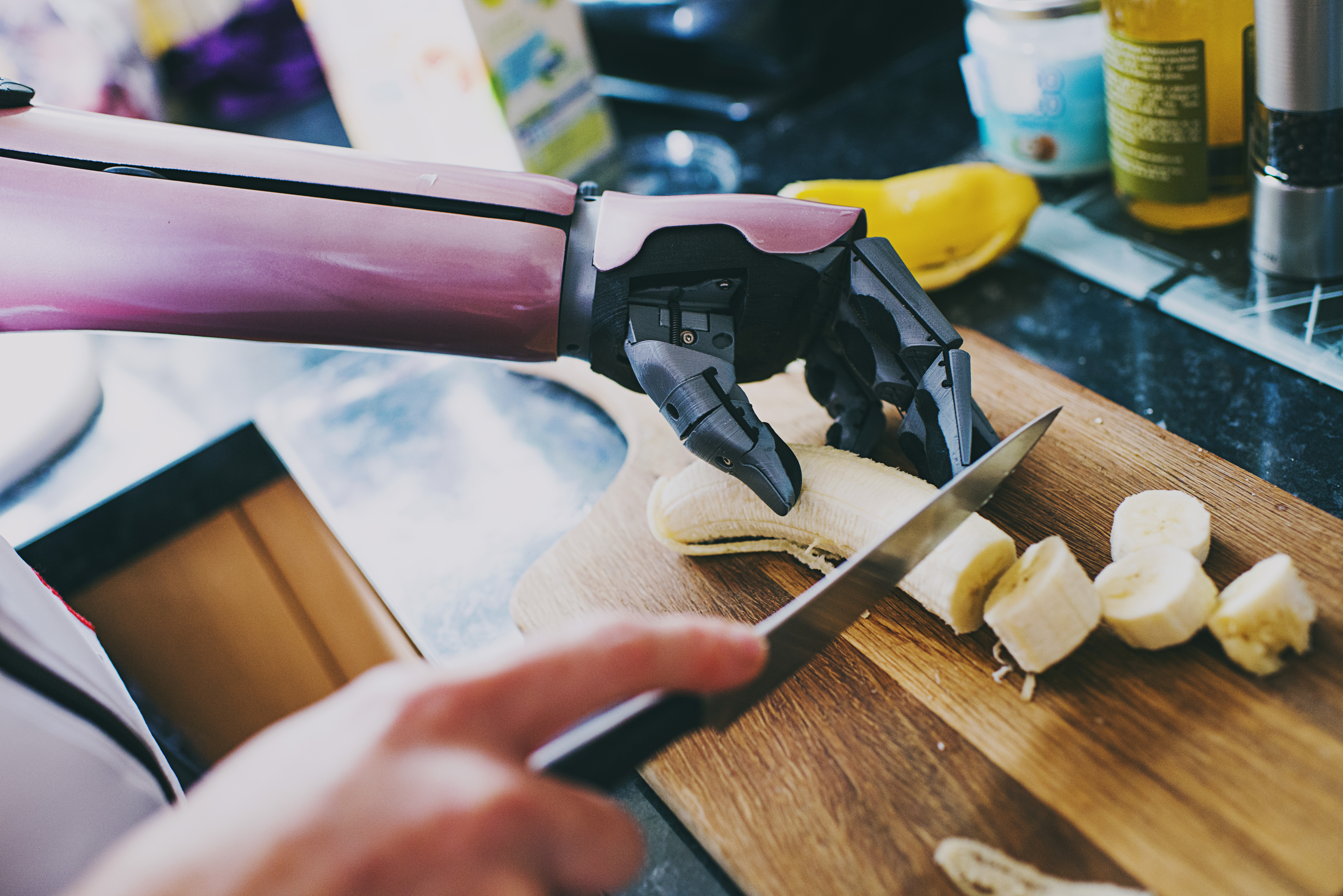 A bionic arm cutting banana