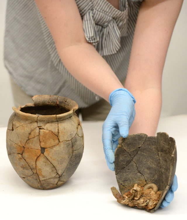 Cremation urns containing the remains of a woman and child are going on display for the first time (English Heritage/PA)