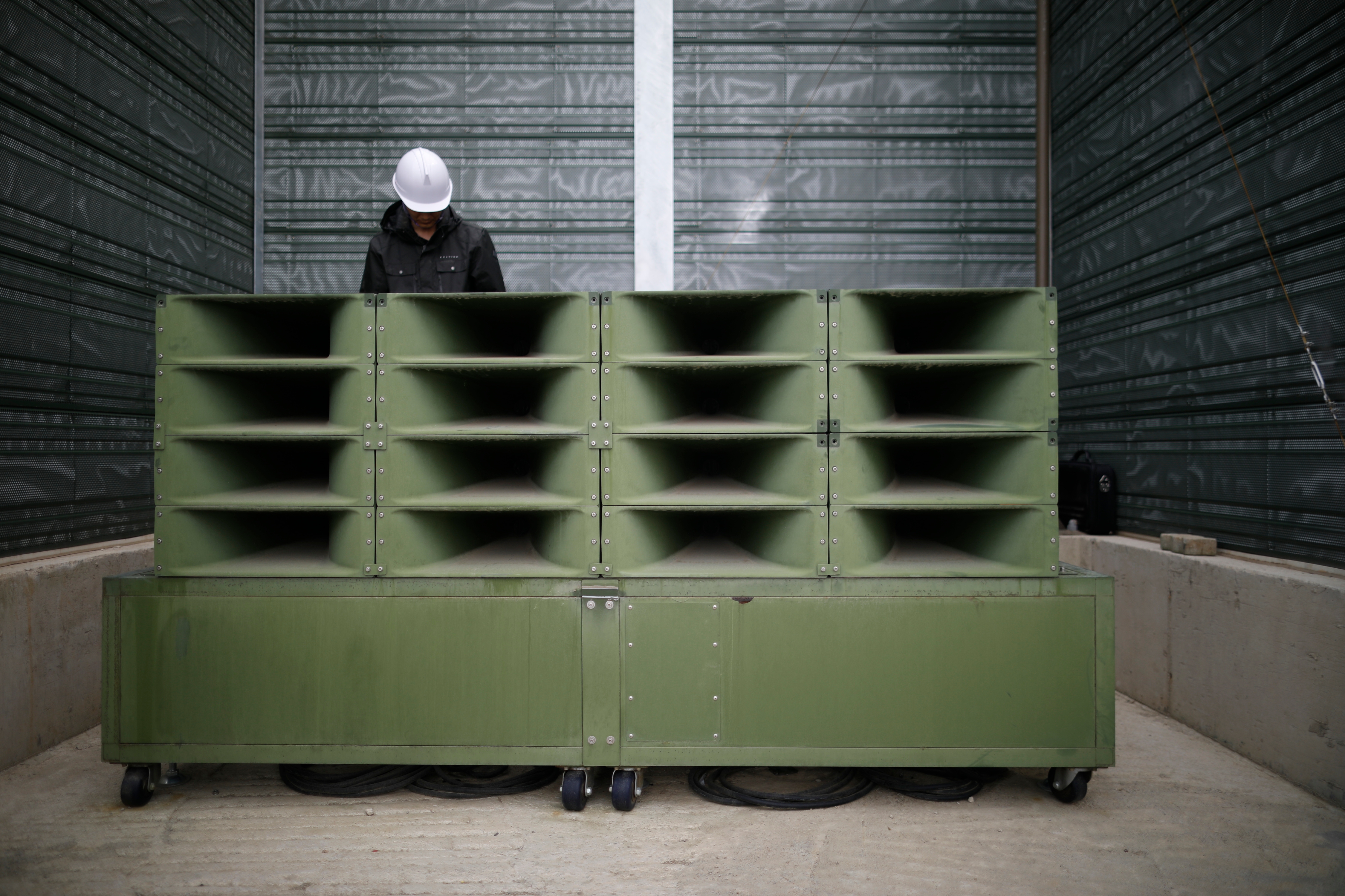 A worker dismantles loudspeakers (Kim Hong-Ji/Pool Photo via AP)