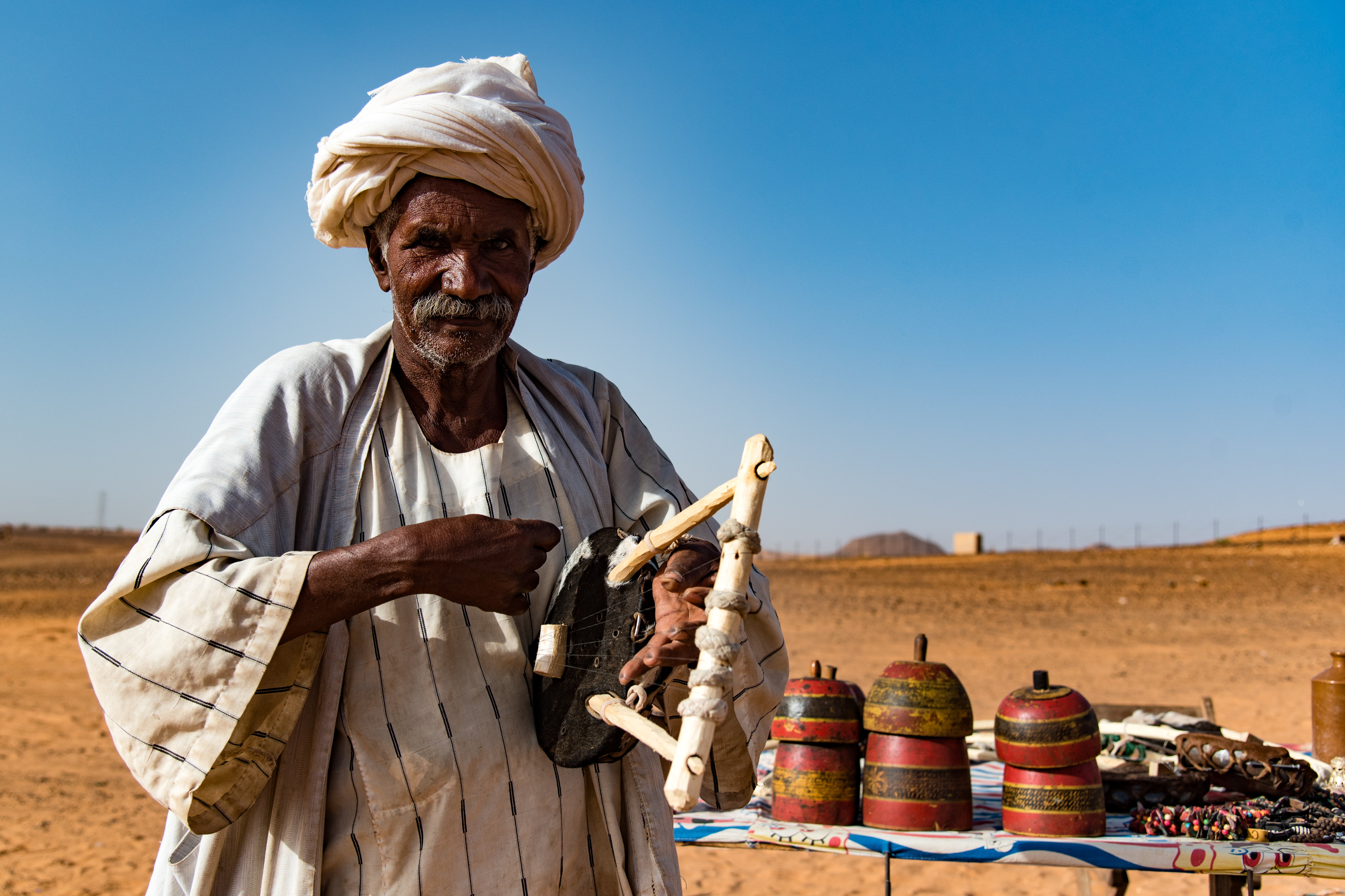 A souvenir seller outside the pyramids of Meroe (Sarah Marshall/PA)