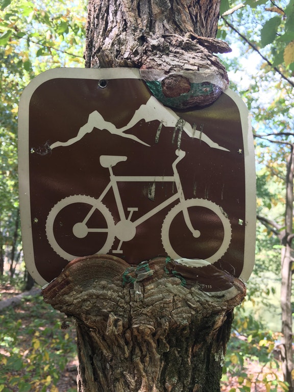 A cycling sign with paint coming off