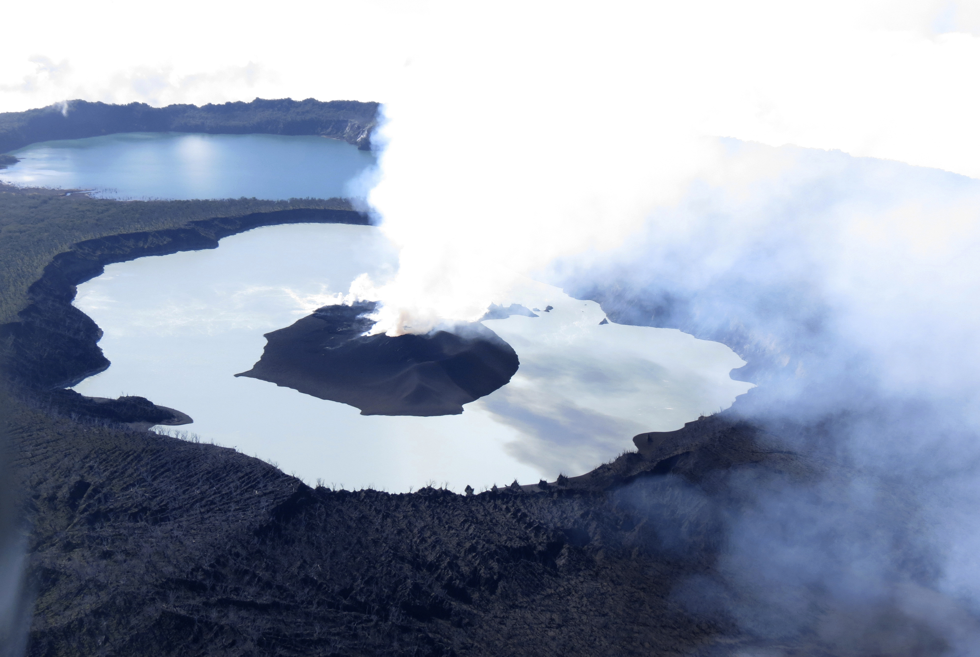 Steam rises from the volcanic cone that has formed in Lake Vui near the summit of Ambae Island, Vanuatu (Brad Scott/GeoHazards Divison, VMGD via AP)