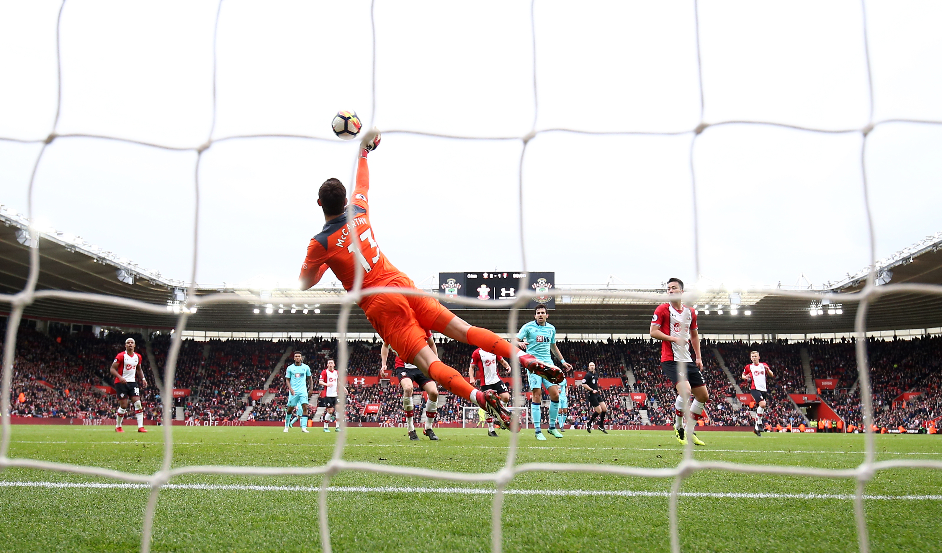 Southampton's goalkeeper dives for the ball against Bournemouth