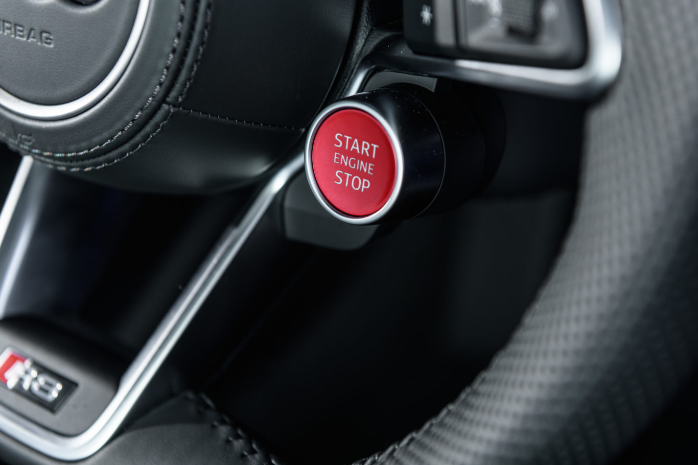 The large red starter button is a design focus in the cabin 