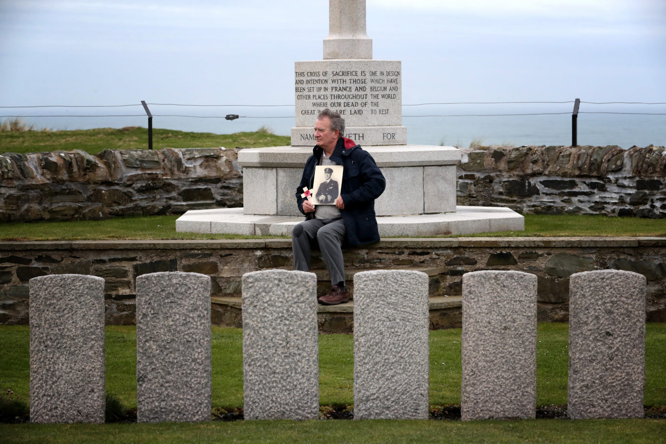 Nick Hide in the graveyard where his grandfather Captain Ernest Davidson, who died in the HMS Otranto disaster which sank off the coast of Islay in 1918, is buried (Jane Barlow/PA)