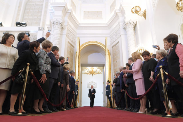 Vladimir Putin enters the ceremonial hall at the Kremlin