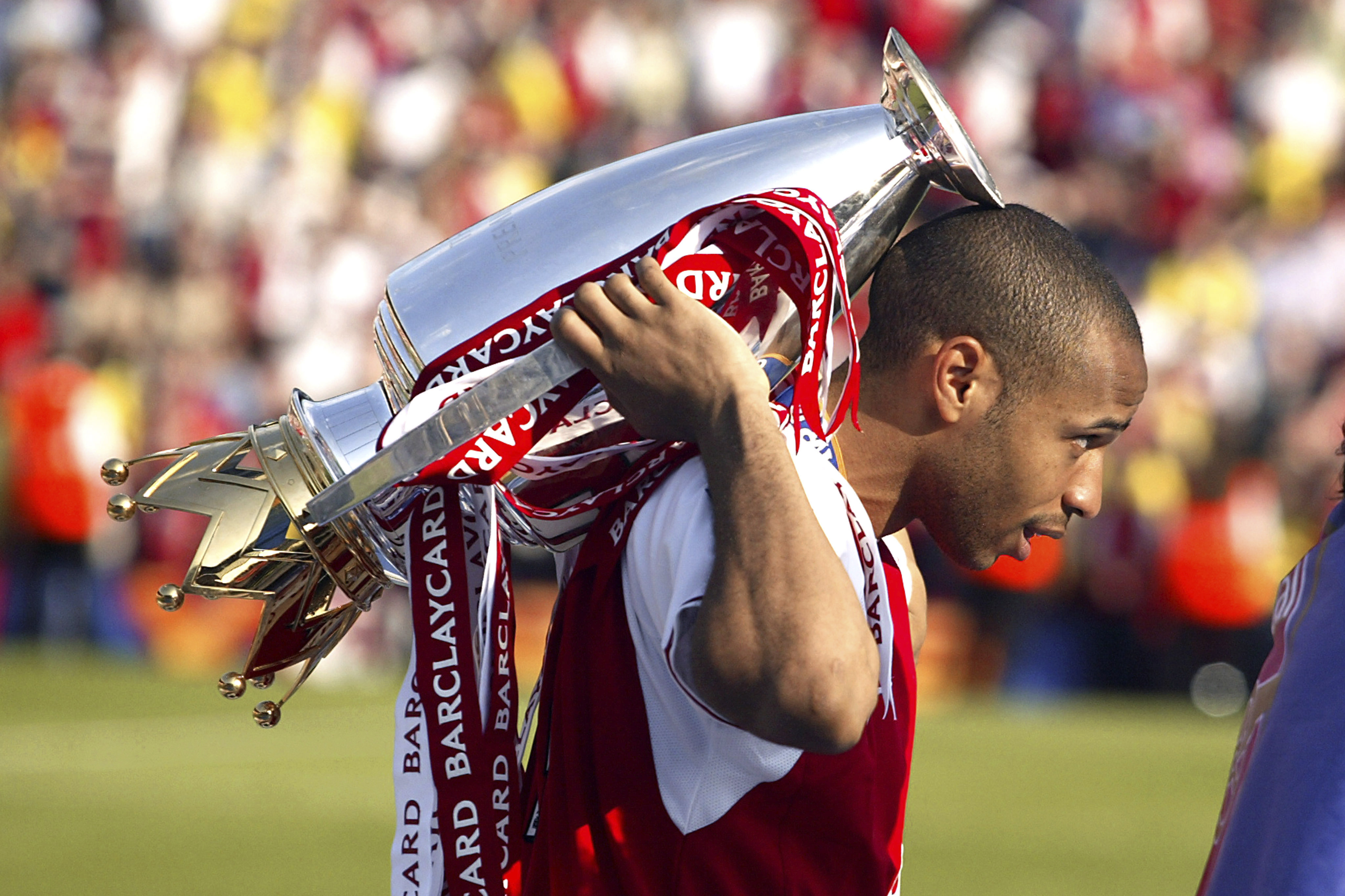Thierry Henry celebrates winning the Premier League with Arsenal