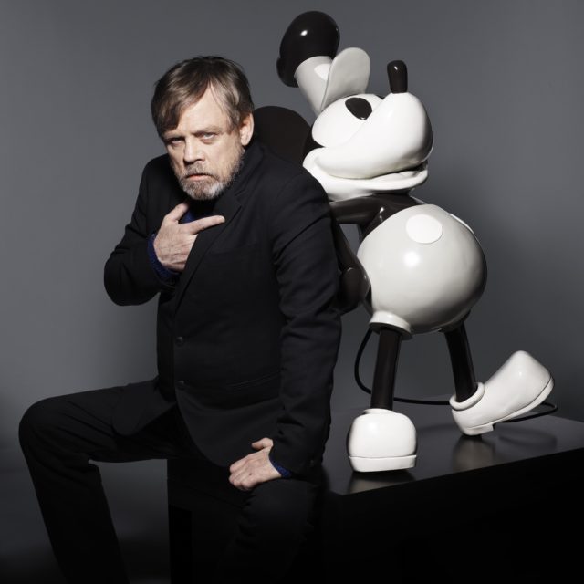 Star Wars star Mark Hamill poses alongside a special, commemorative statue of Mickey Mouse. 