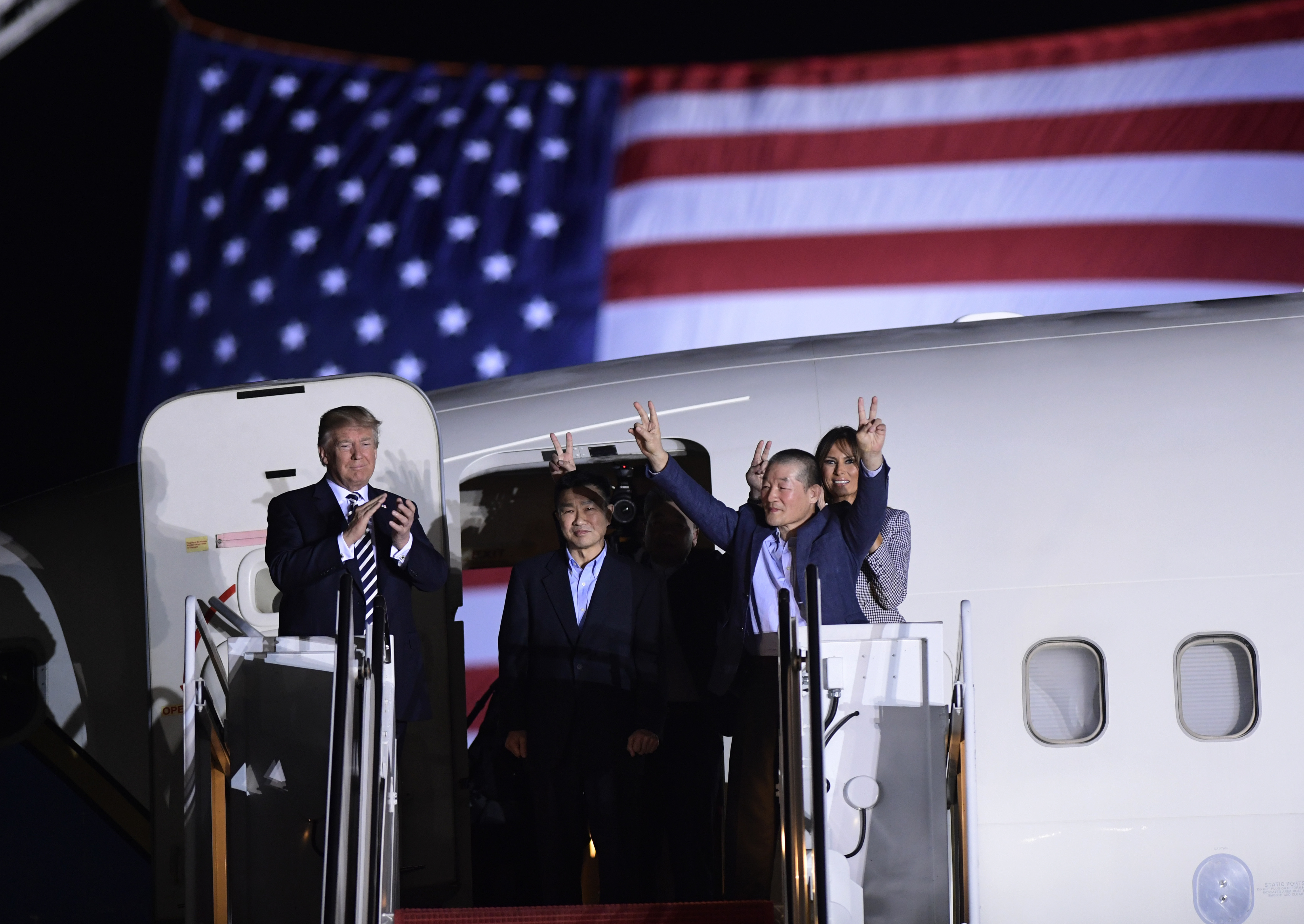 Mr Trump and the three released men at Andrews Air Force Base in Maryland (Susan Walsh/AP)