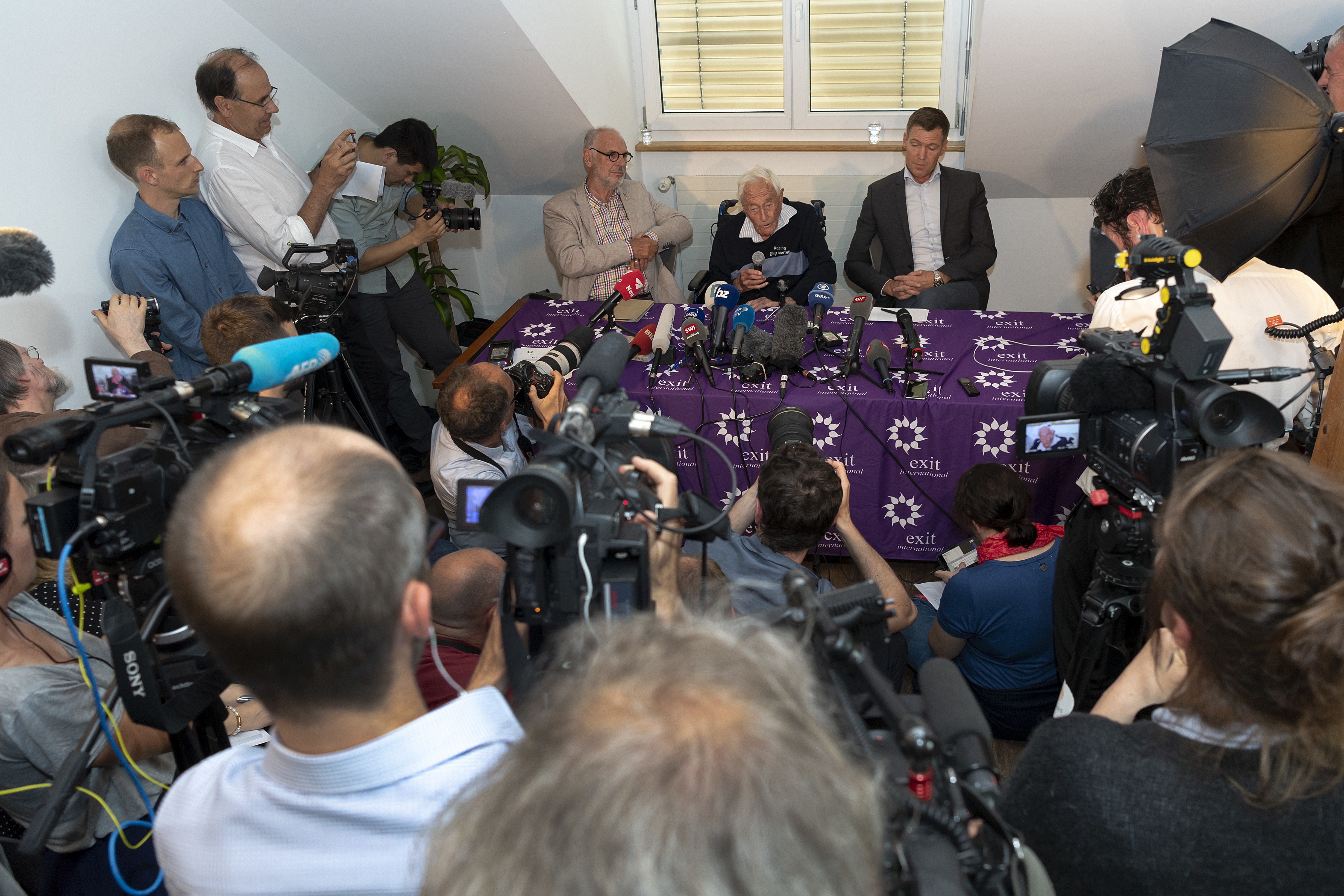 David Goodall and others at a press conference (Georgios Kefalas/Keystone via AP)