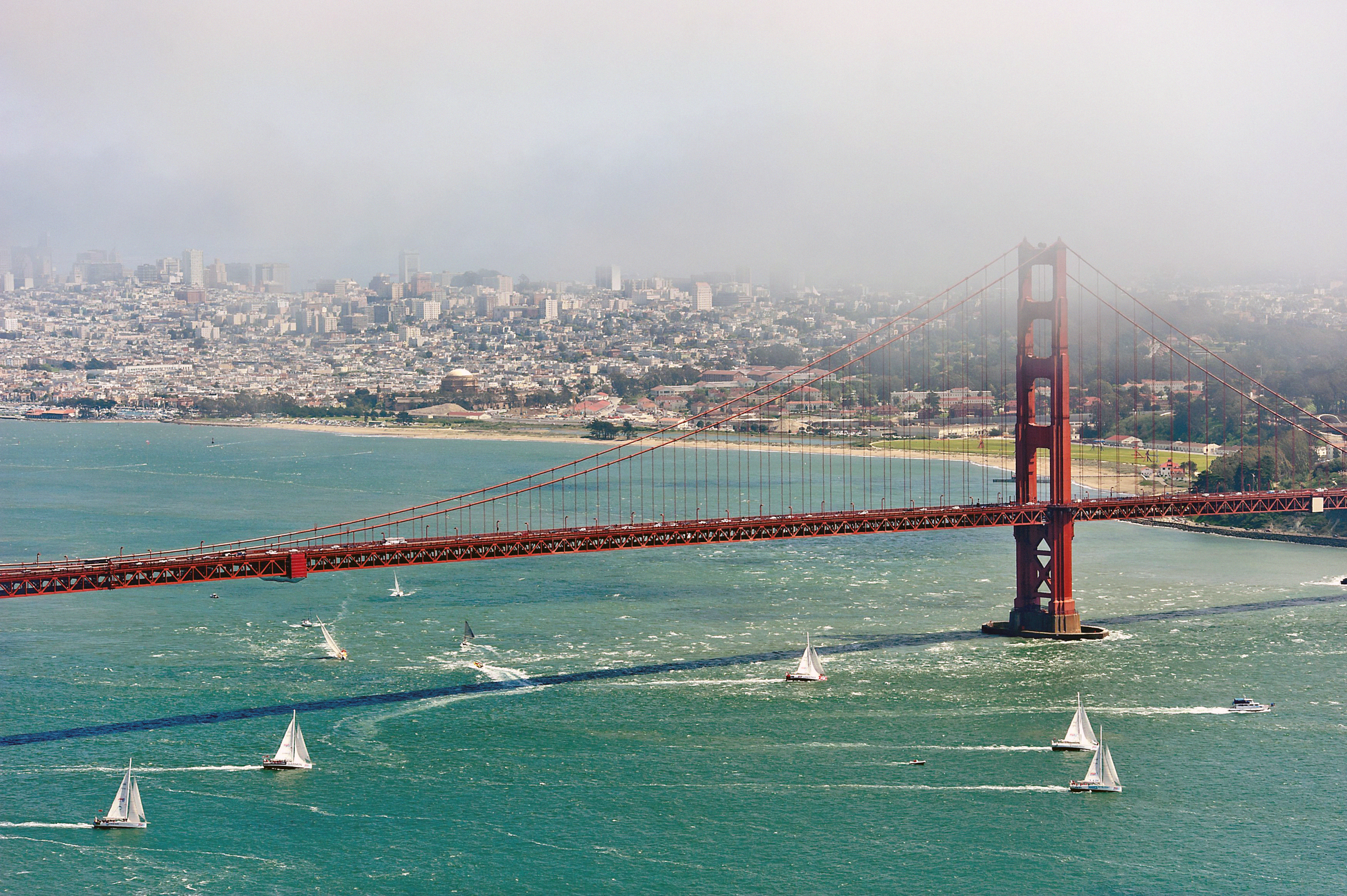 A yacht race takes place near the Golden Gate Bridge in San Francisco