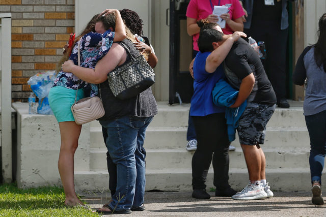 Students and parents wait to reunite after the shooting