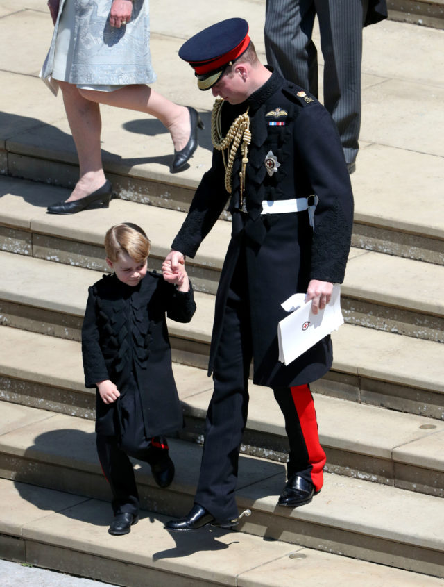 Tightly gripping his father's hand, Prince George braves the crowds (Andrew Matthews/PA)