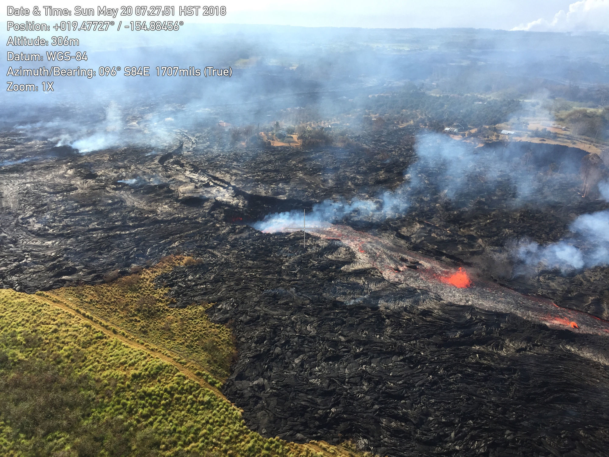 Lava from the eastern channel of the Fissure 20 complex flows into a crack in the ground in Pahoa (US Geological Survey via AP)