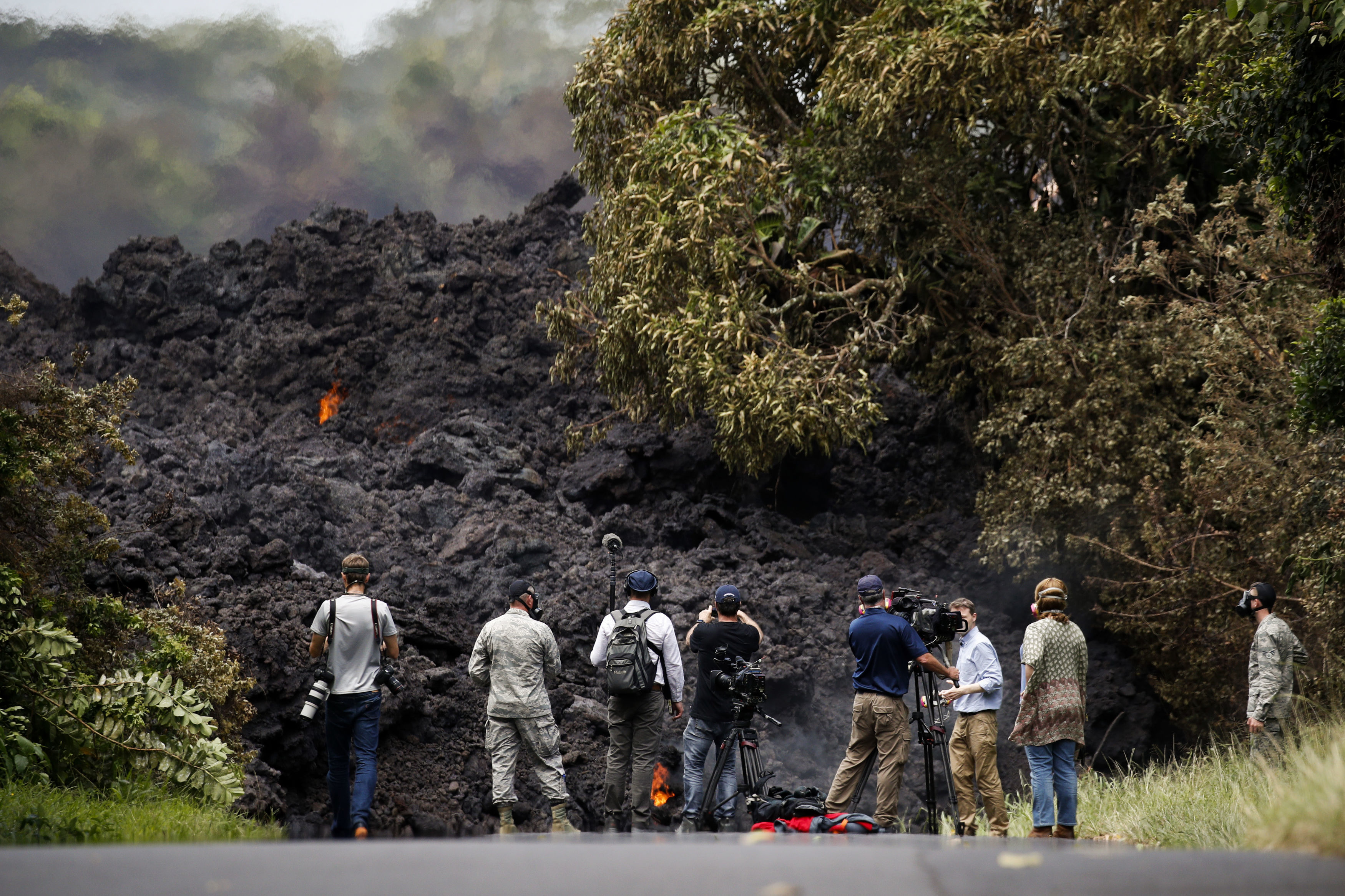 Members of the media record a wall of lava entering the ocean near Pahoa (Jae C Hong/AP)