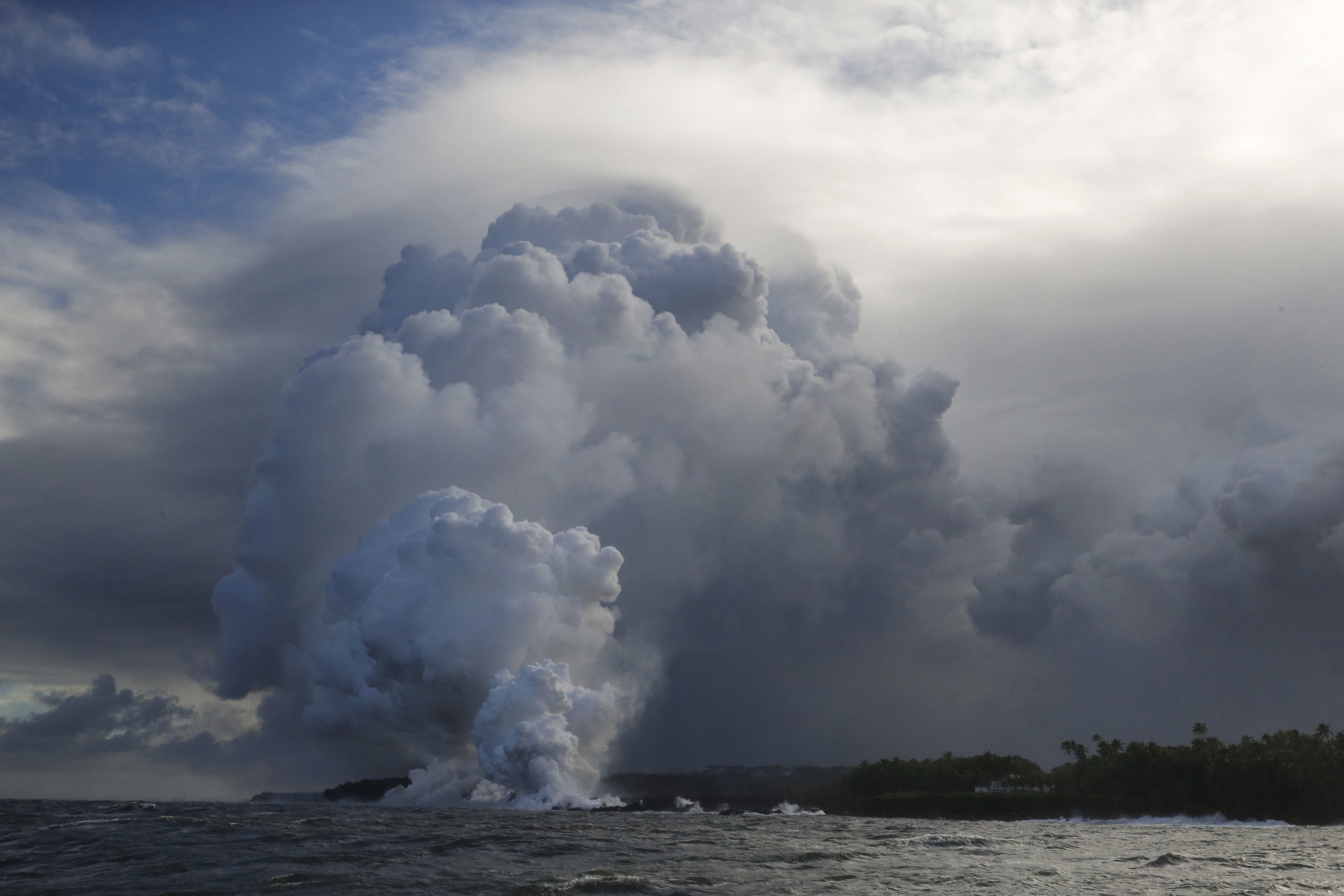A plume of steam rises as lava enters the ocean near Pahoa (Jae C Hong/AP)