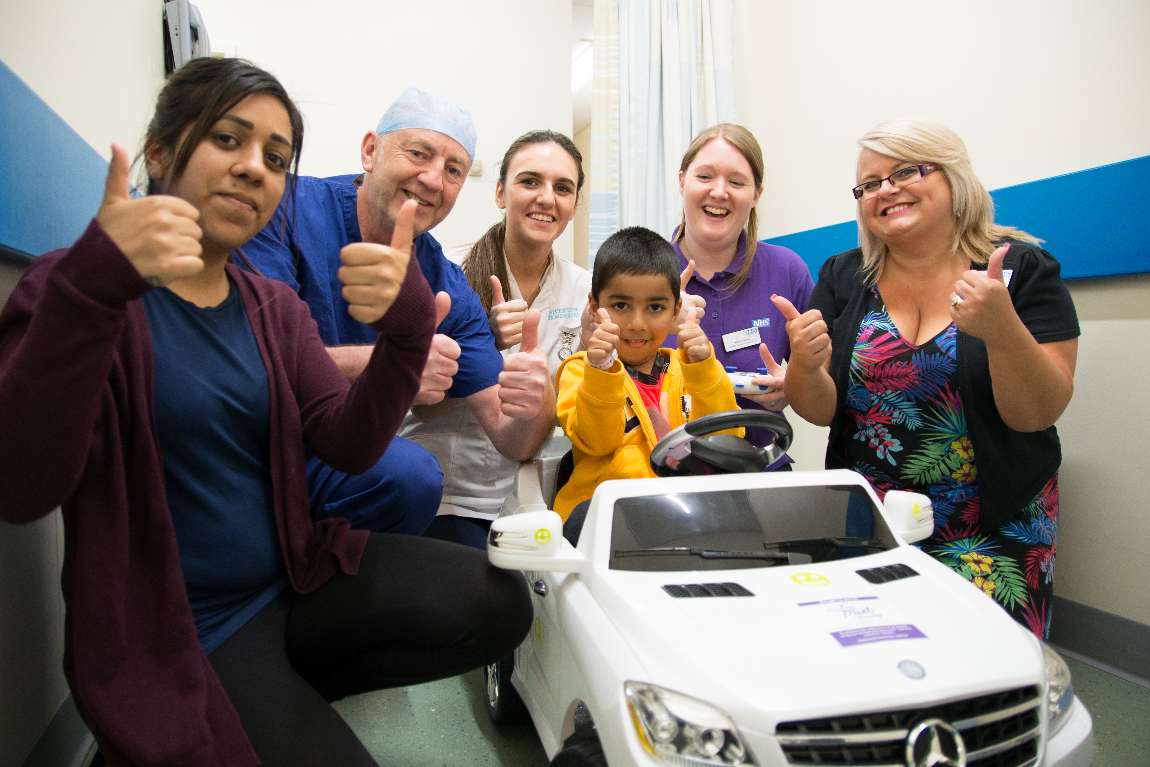 Gavy Saini, centre, with his mother, from left, Sundeep Saini, Jim Morrissey, Advanced Theatre Practitioner, Sophie Winstanley, Student Nurse, Abigail Hanlon, Play Specialist and Amanda Winwood, fundraising manager for Your Trust Charity. (Sandwell and West Birmingham Hospitals NHS Trust/PA)