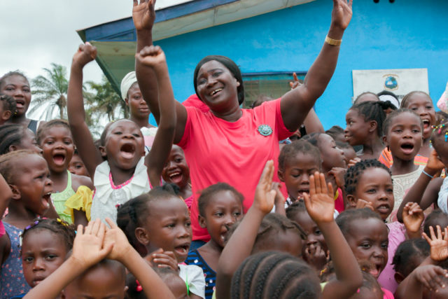 Alice the midwife celebrates with girls named after her outside White Plains Clinic, Liberia (Save the Children)