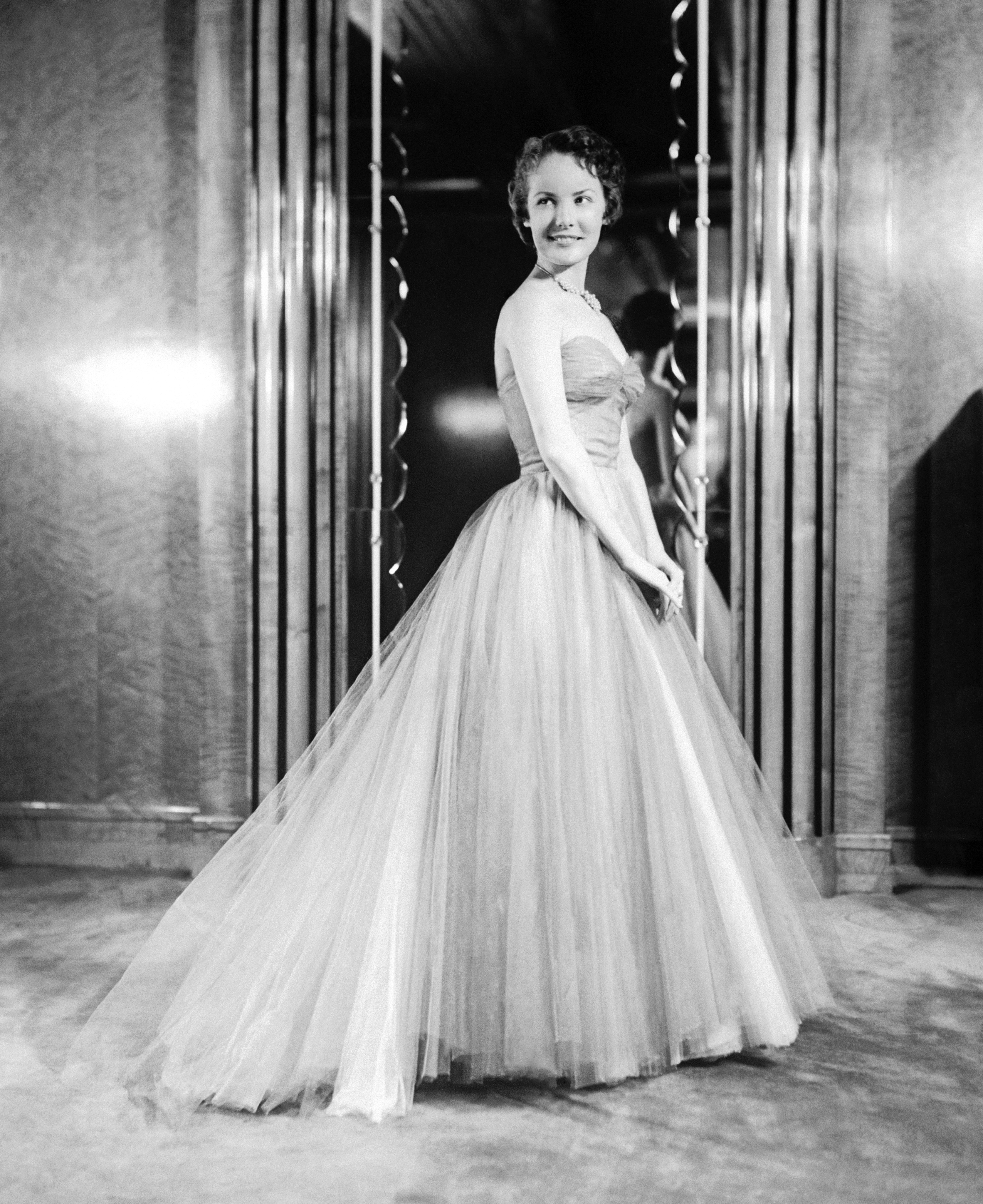 British film actress Petula Clark gives a preview of the gown she will wear for the Royal Film Performance in 1950