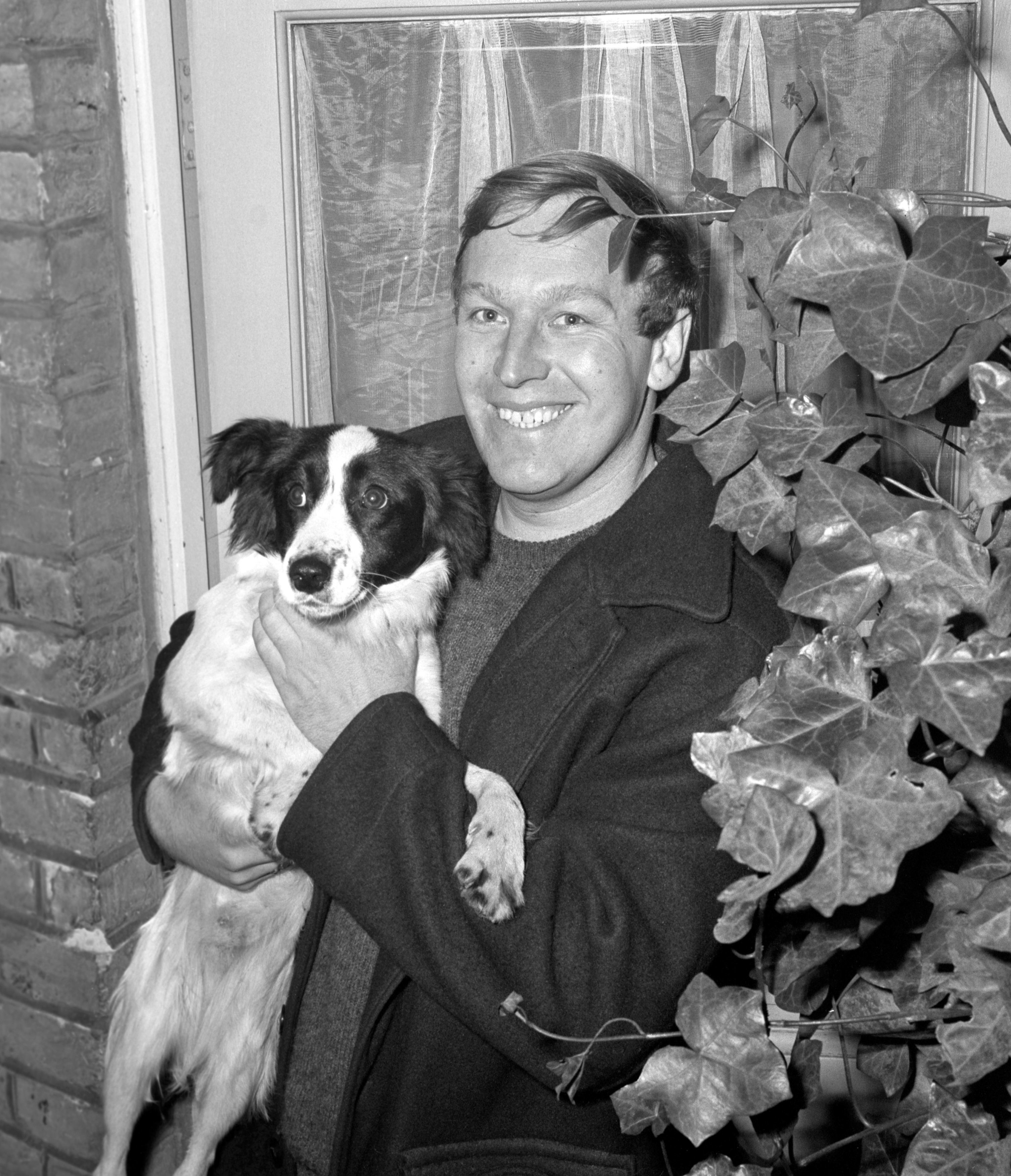 David Corbett and his dog Pickles, who found the trophy in bushes outside his owner's south London home (PA)