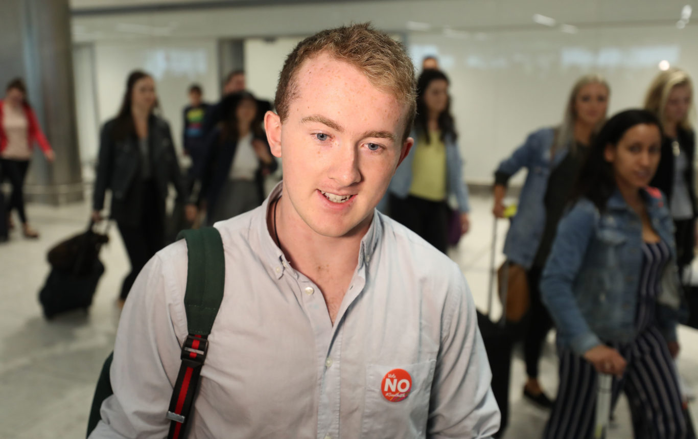 Eoin O'Loughlan arriving from London at Dublin Airport to vote in the referendum to repeal the 8th amendment (Niall Carson/PA)