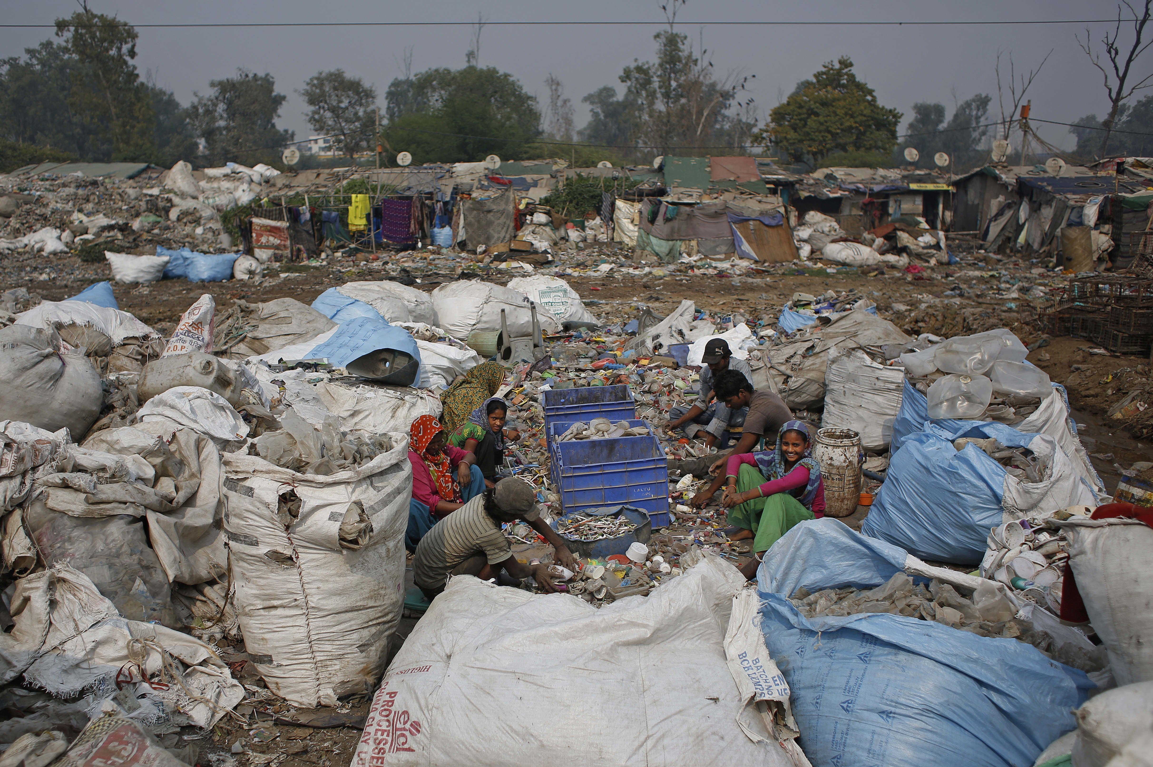 A family of rubbish collectors sort reusable waste in New Delhi