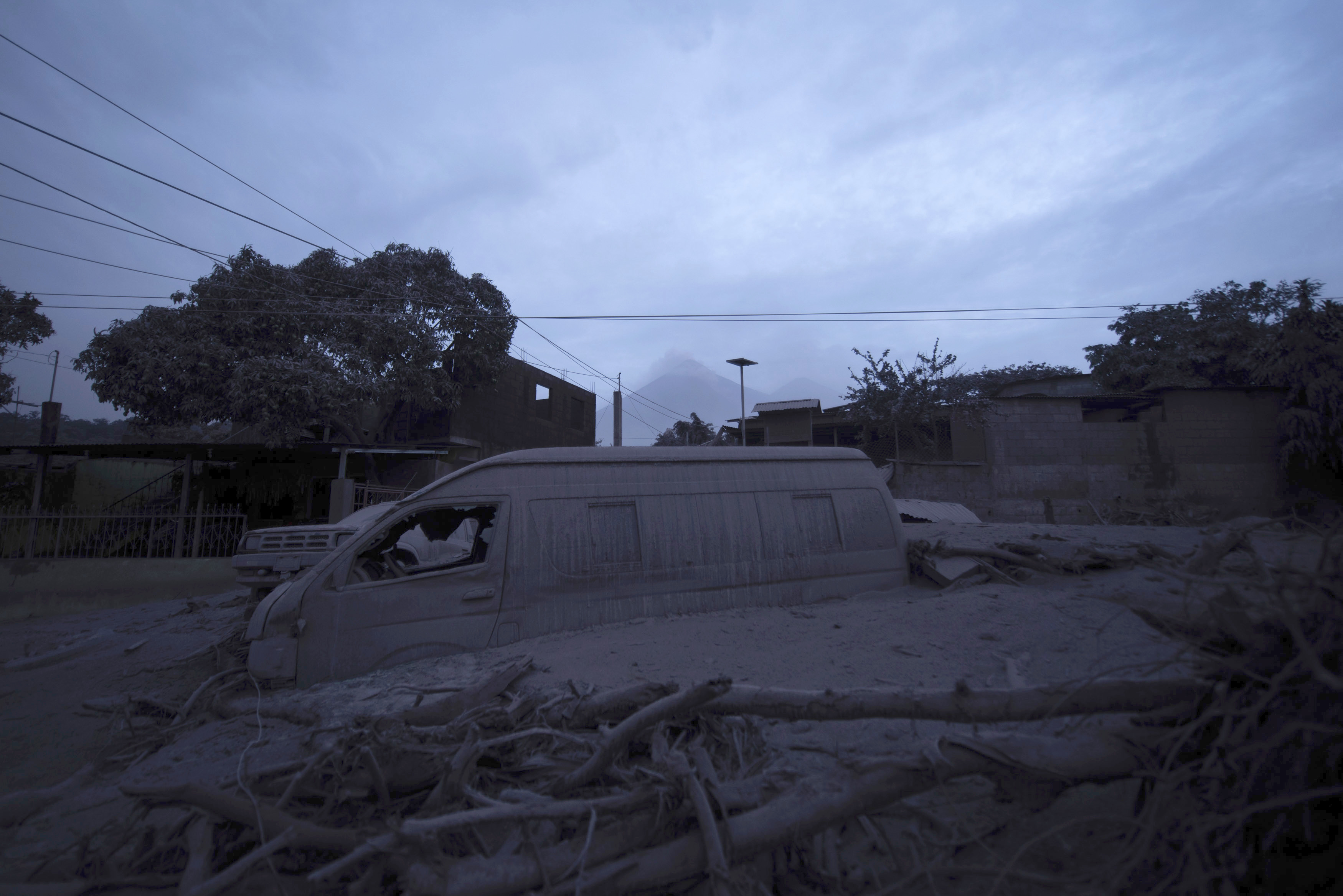 A vehicle partially buried in volcanic ash