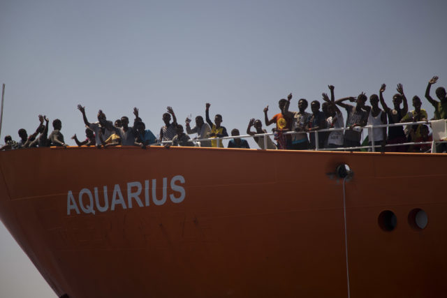 Migrants wave from the Aquarius rescue ship